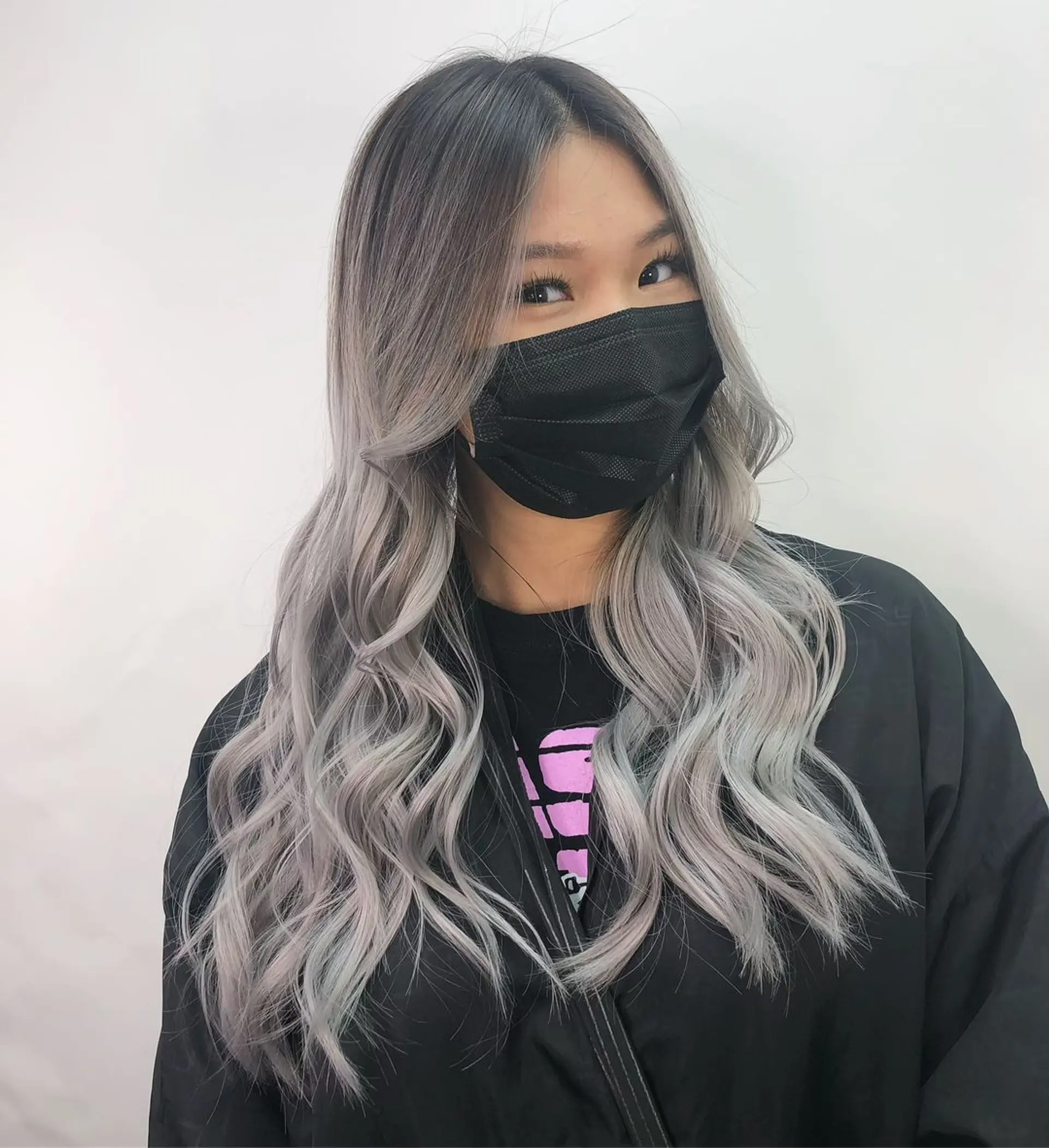 Long, wavy hairstyle with a gradient color transition from darker roots to striking silver and platinum hues, styled in loose waves with a middle part.
Stylist - @xcellent_jason 1