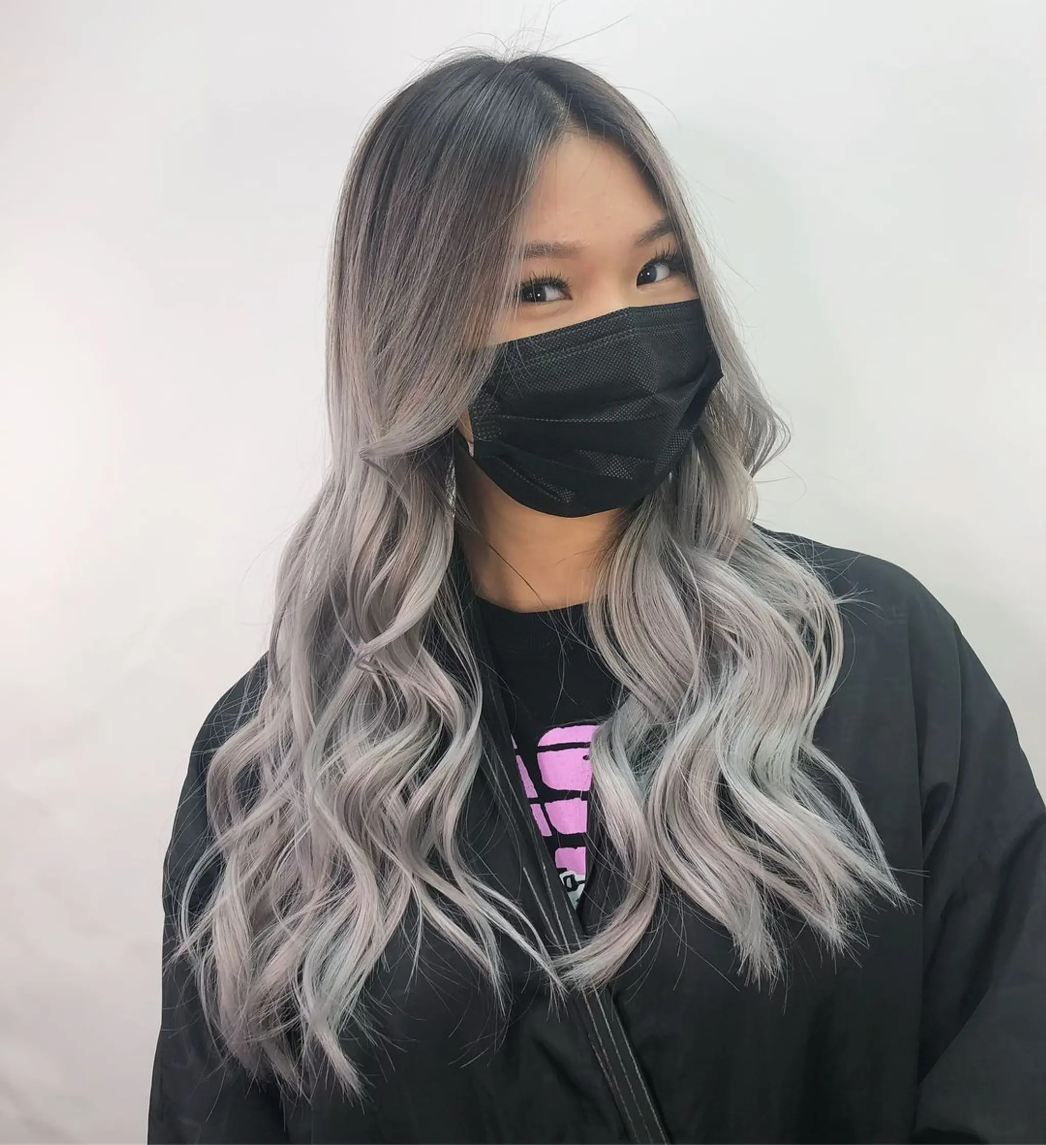 Long, wavy hairstyle with a gradient color transition from darker roots to striking silver and platinum hues, styled in loose waves with a middle part.
Stylist - @xcellent_jason