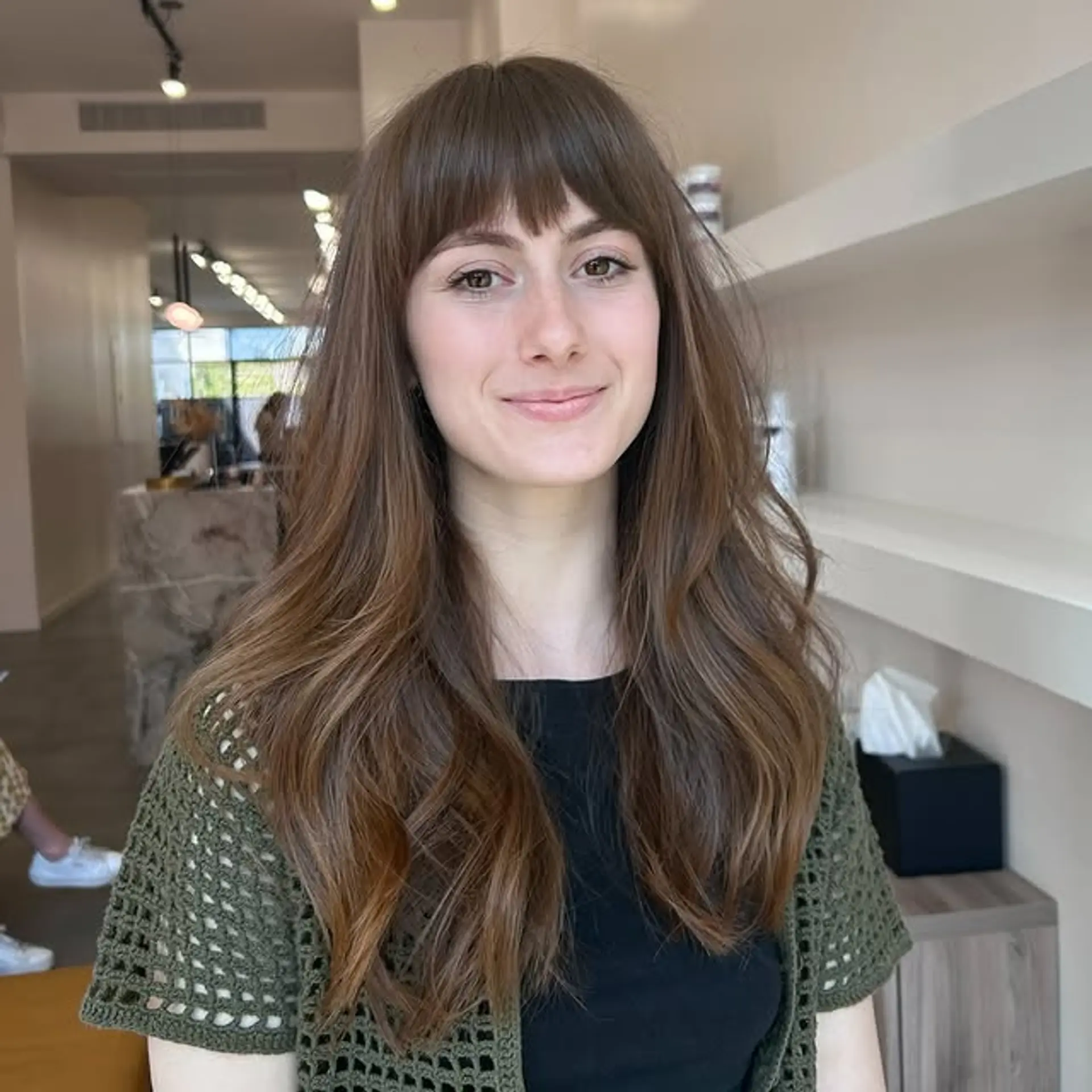 Long wavy hairstyle with curtain bangs and face-framing layers. 1