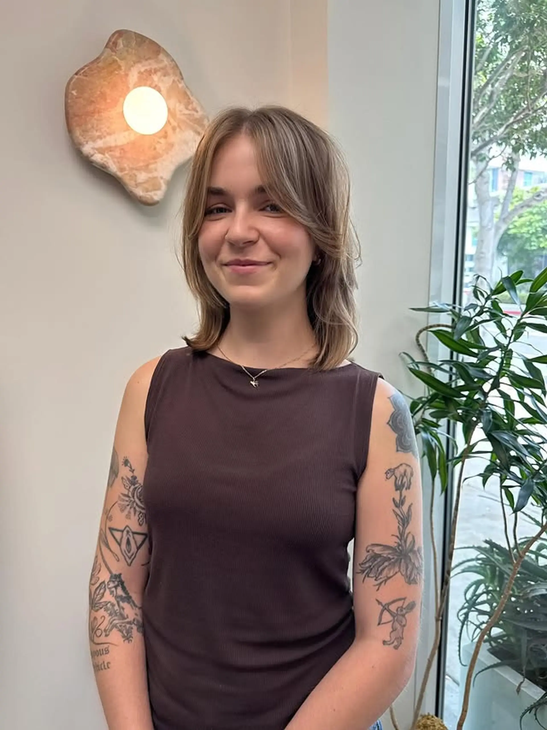 A stylish medium-length shag haircut with face-framing layers for added texture and a modern feel. 1