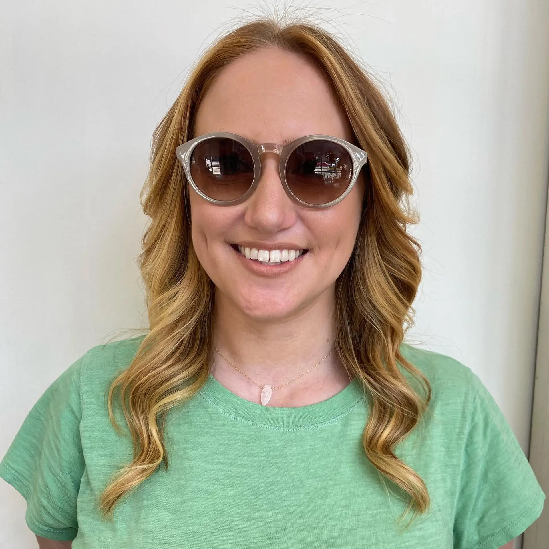 Medium-length warm strawberry blonde hair seamlessly blended into bright golden blonde highlights, styled with soft, loose waves. 1