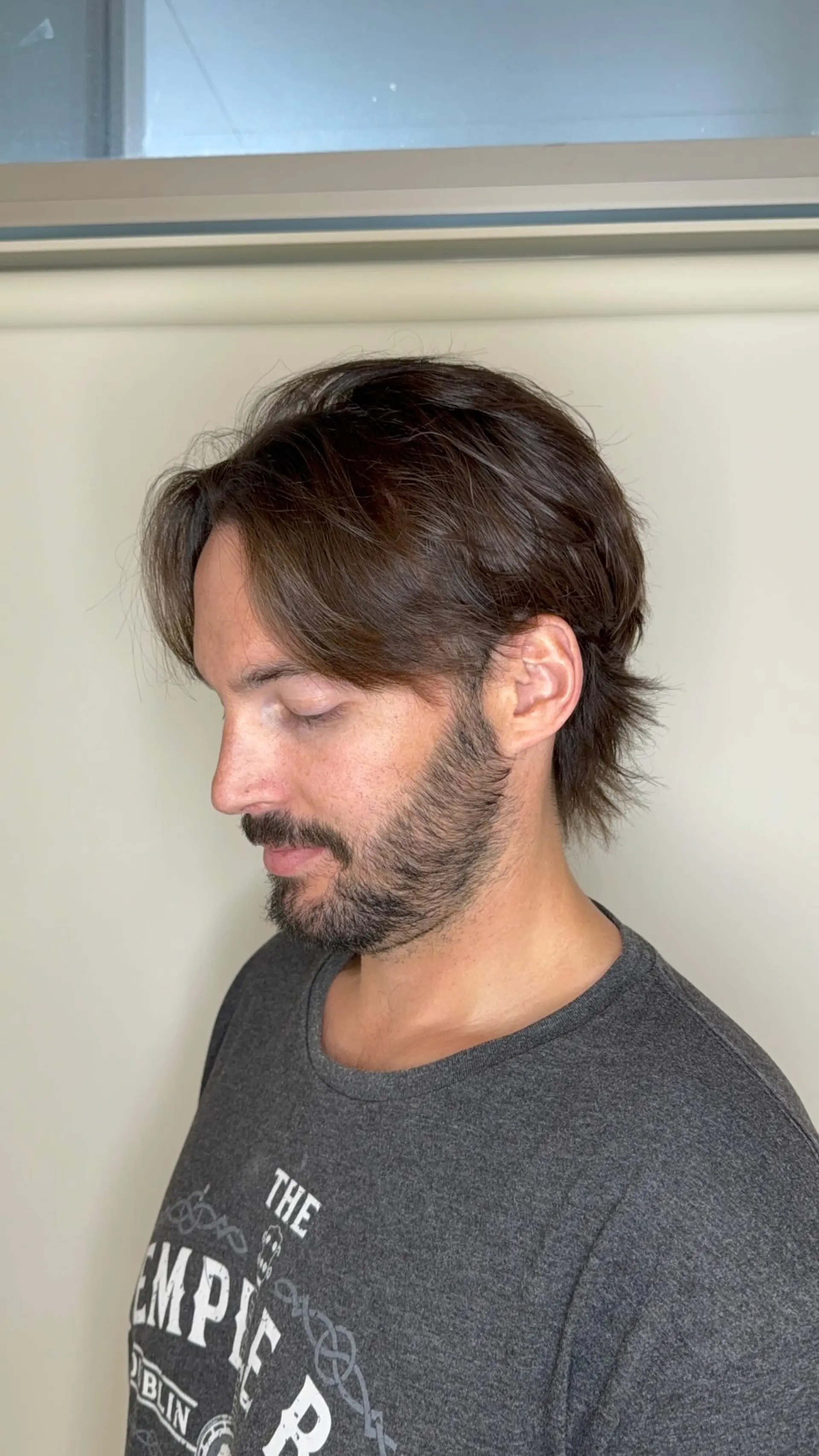 Medium-length textured cut with swept-back curtain layers and feathered ends at the nape. 1
