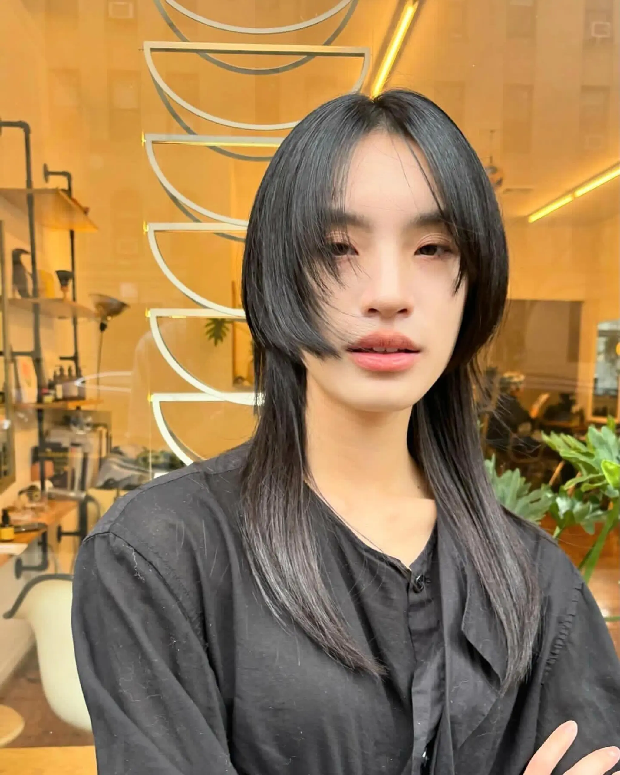 Sleek, straight black hair with medium-length, eye-grazing bangs and face-framing layers, creating a polished and modern look. Haircut by @takeohair 1