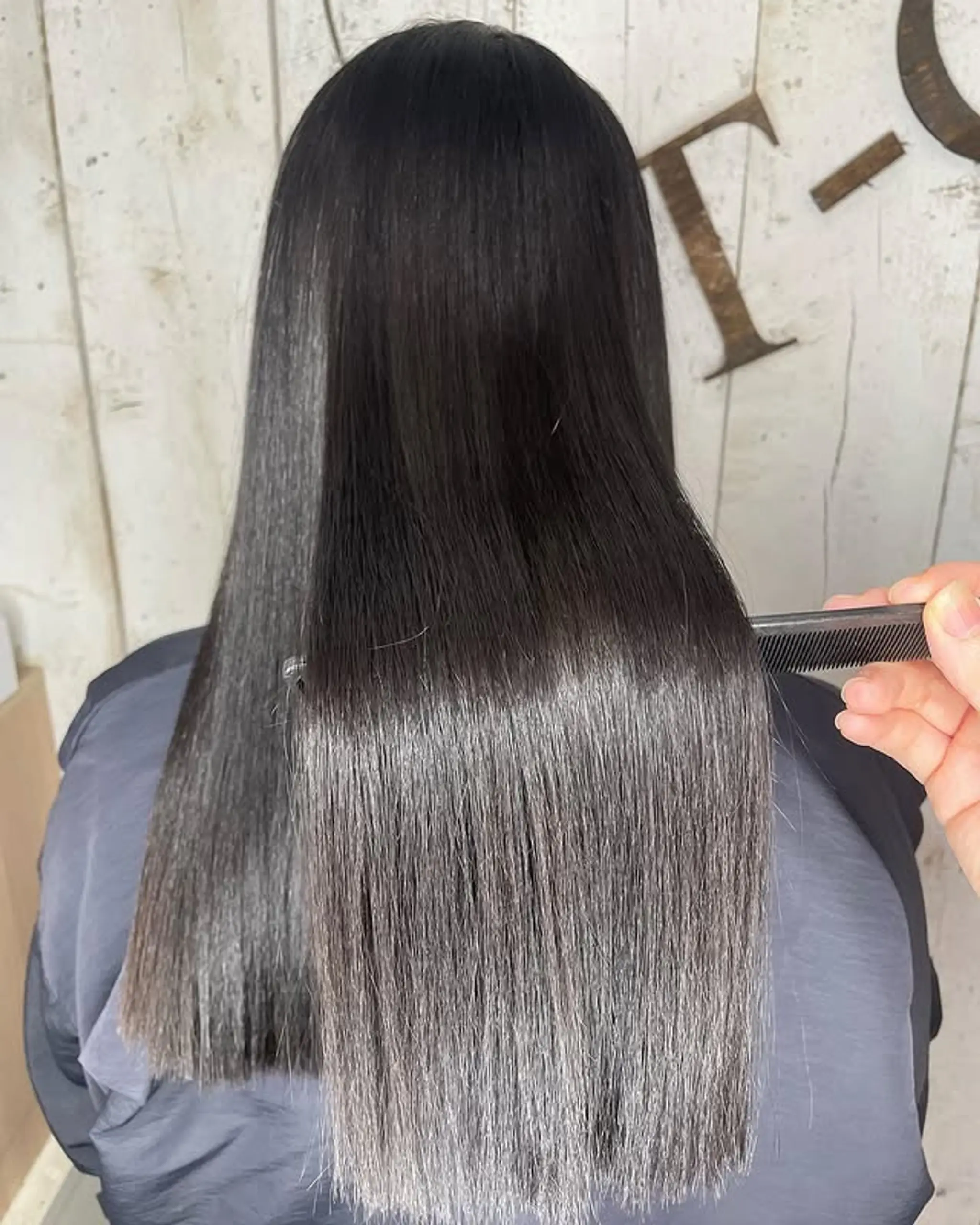 A modern, sleek and shiny straight hairstyle with a blunt cut.