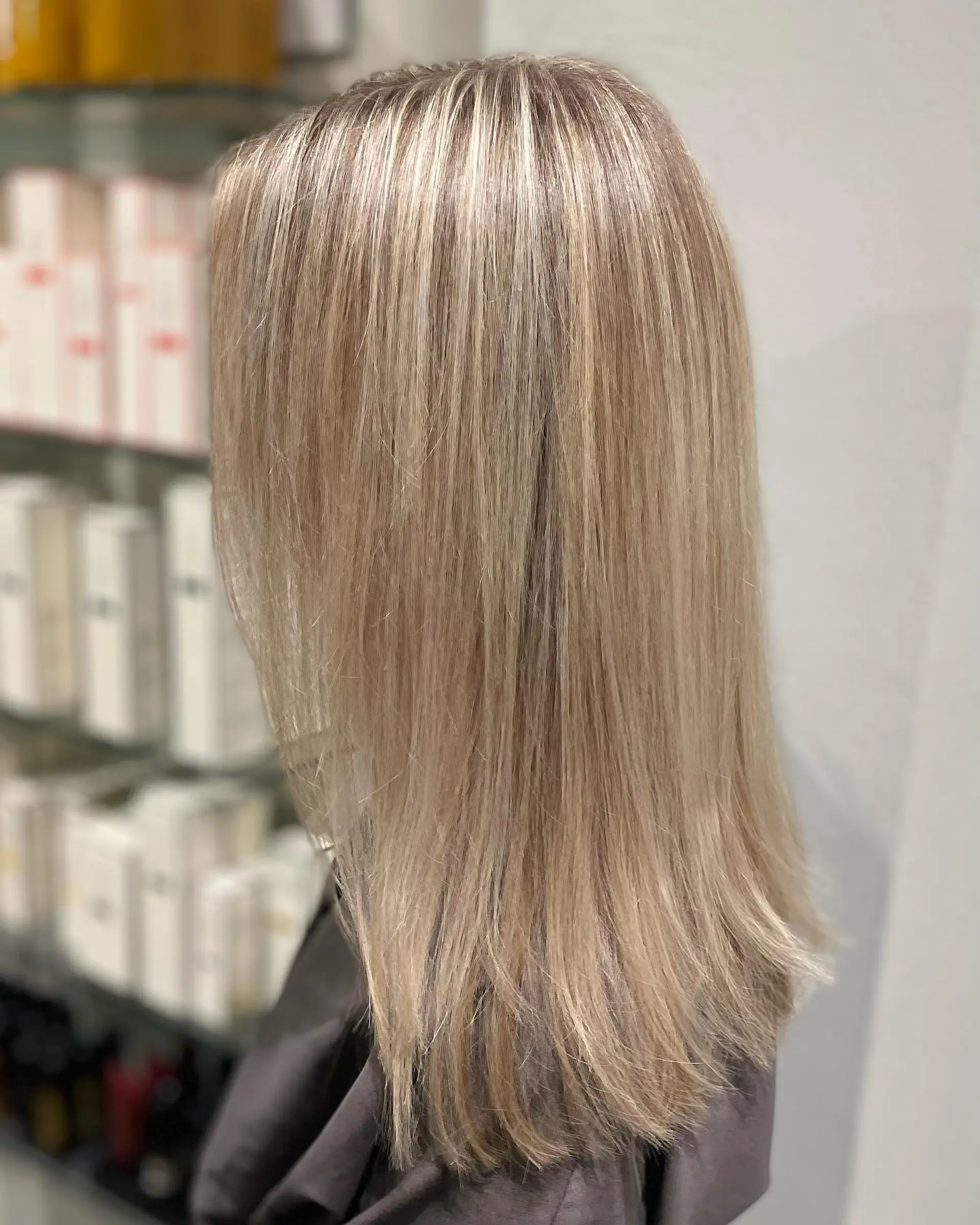 Medium-length straight hair featuring fine, seamless micro-foil blonde highlights with a smooth blowout finish. 1