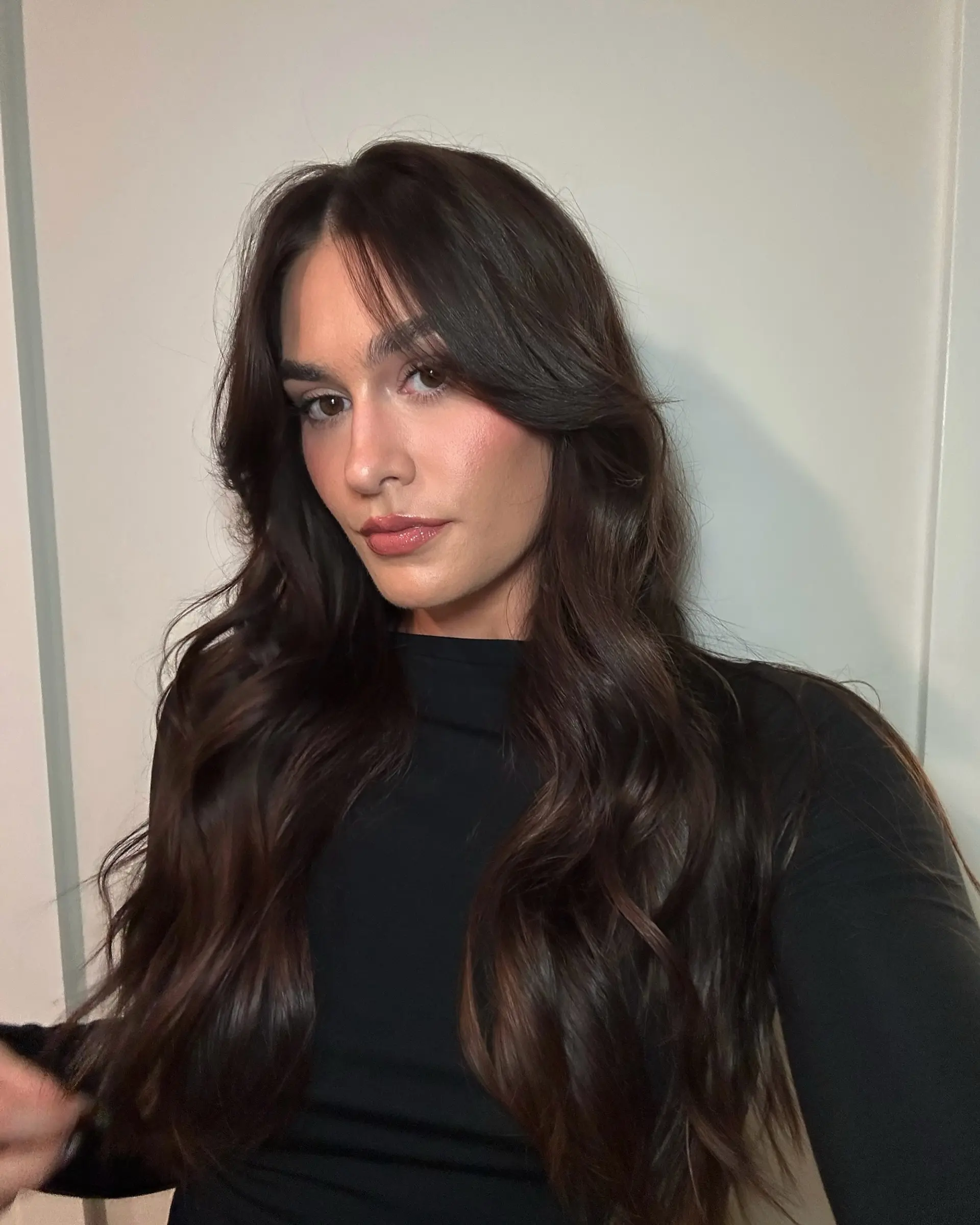 Long, wavy hair with curtain bangs and face-framing layers. 1