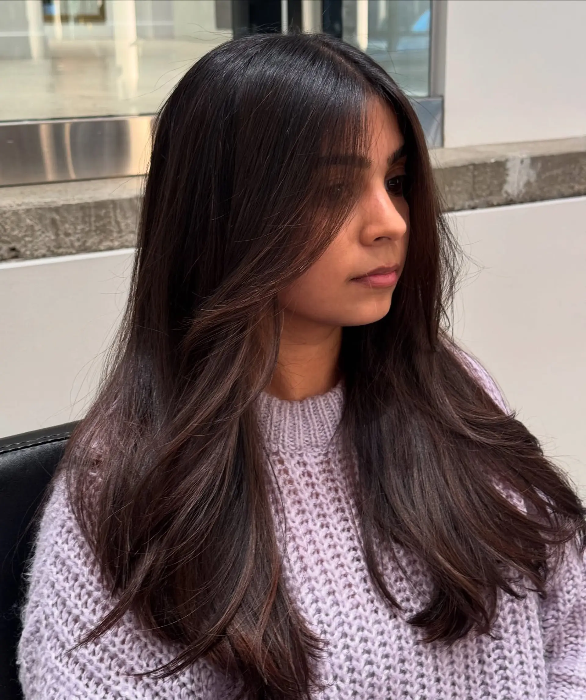 Long, layered brunette with face-framing auburn highlights. 1