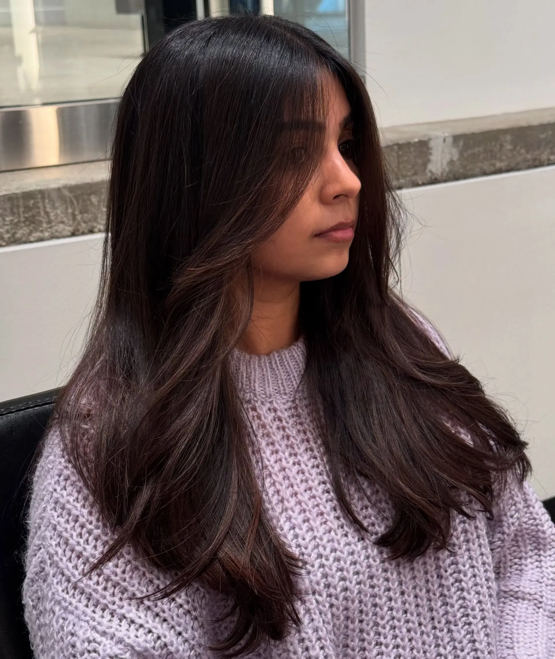 Long, layered brunette with face-framing auburn highlights. 3