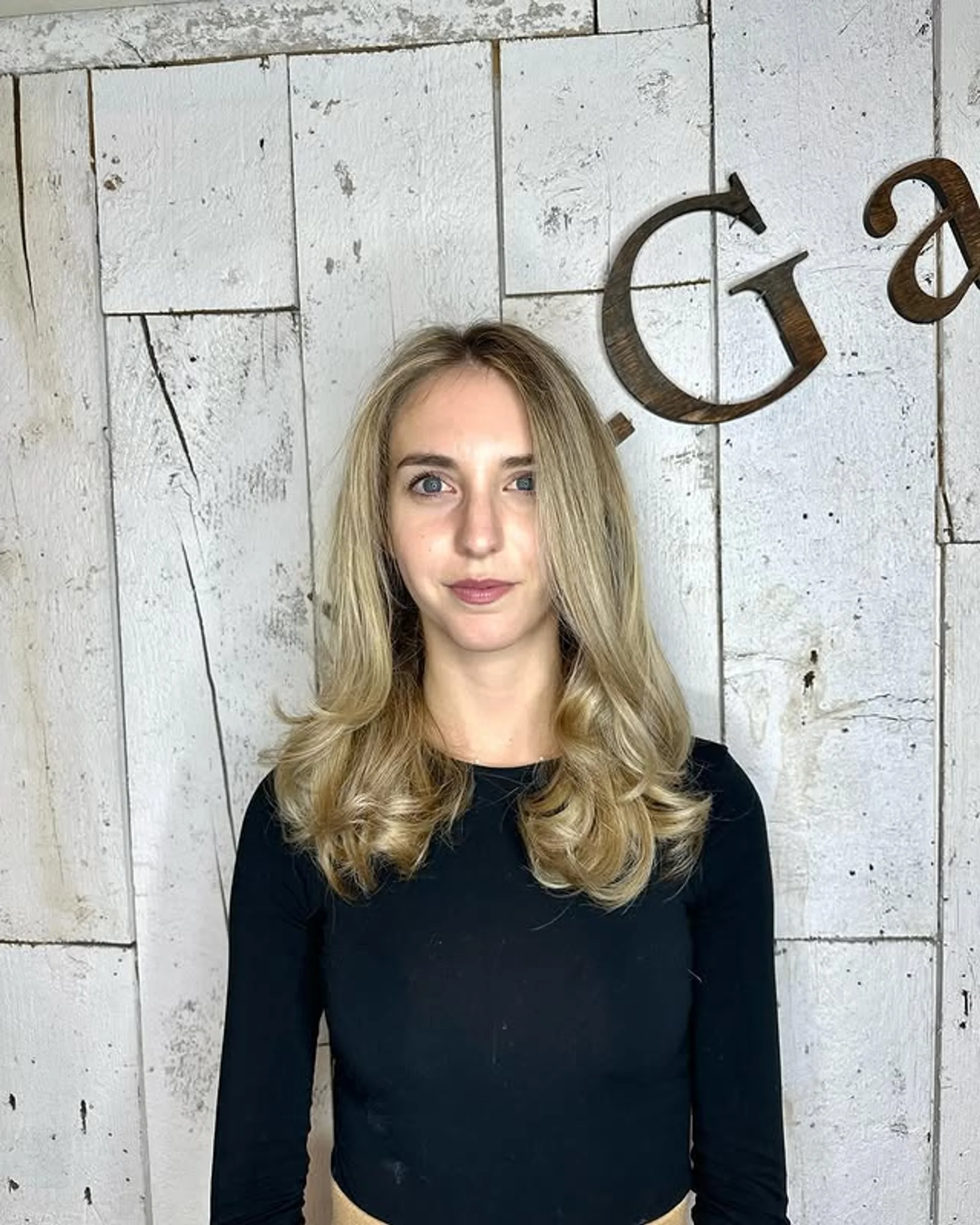 A very long, wavy blonde hairstyle with face-framing layers and sun-kissed highlights, featuring a natural, soft flow and subtle waves. by Coz Salon - Preview 3