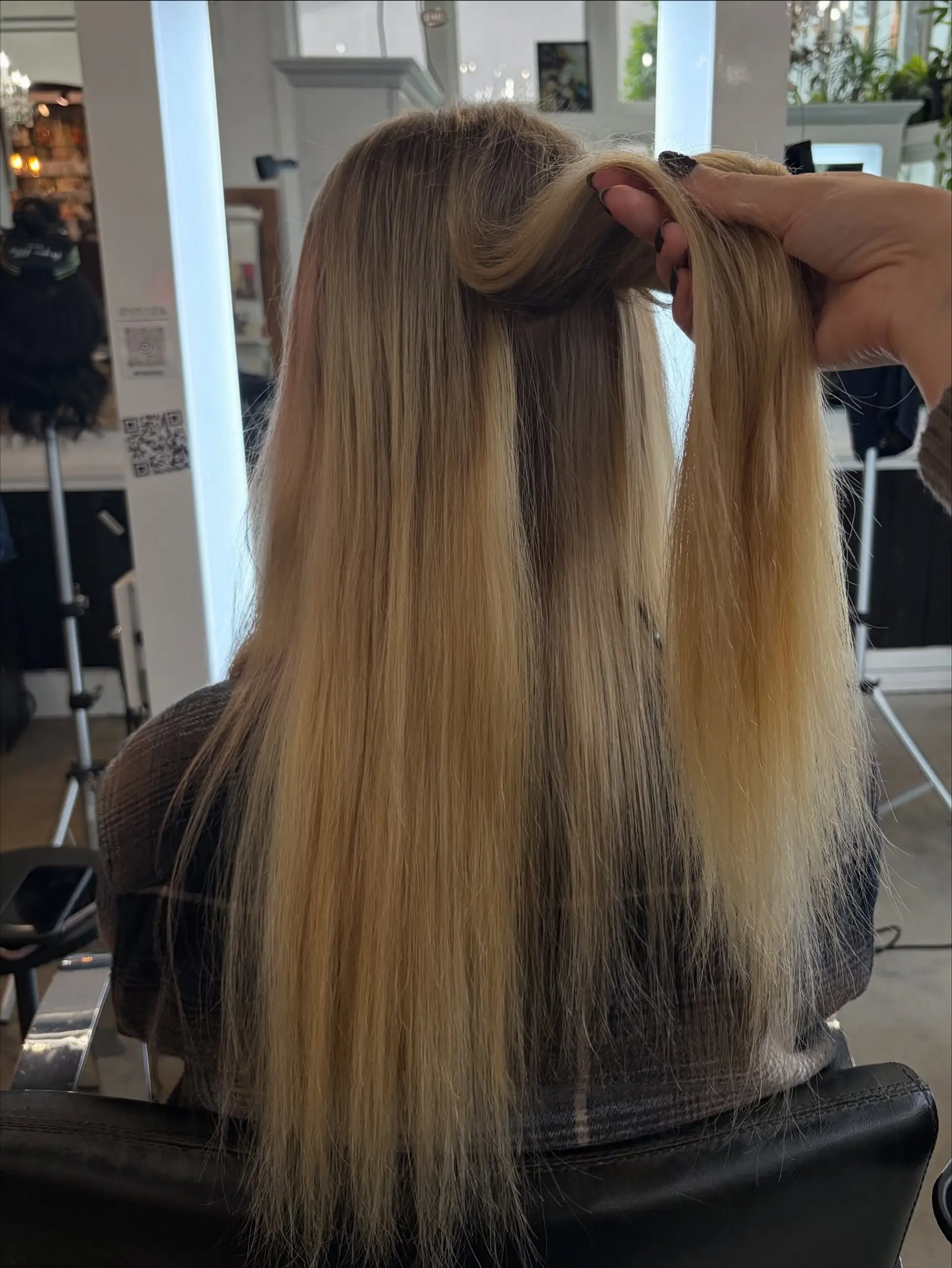 Long, straight multi-tonal blonde hair seamlessly blended with weft hair extensions. 1