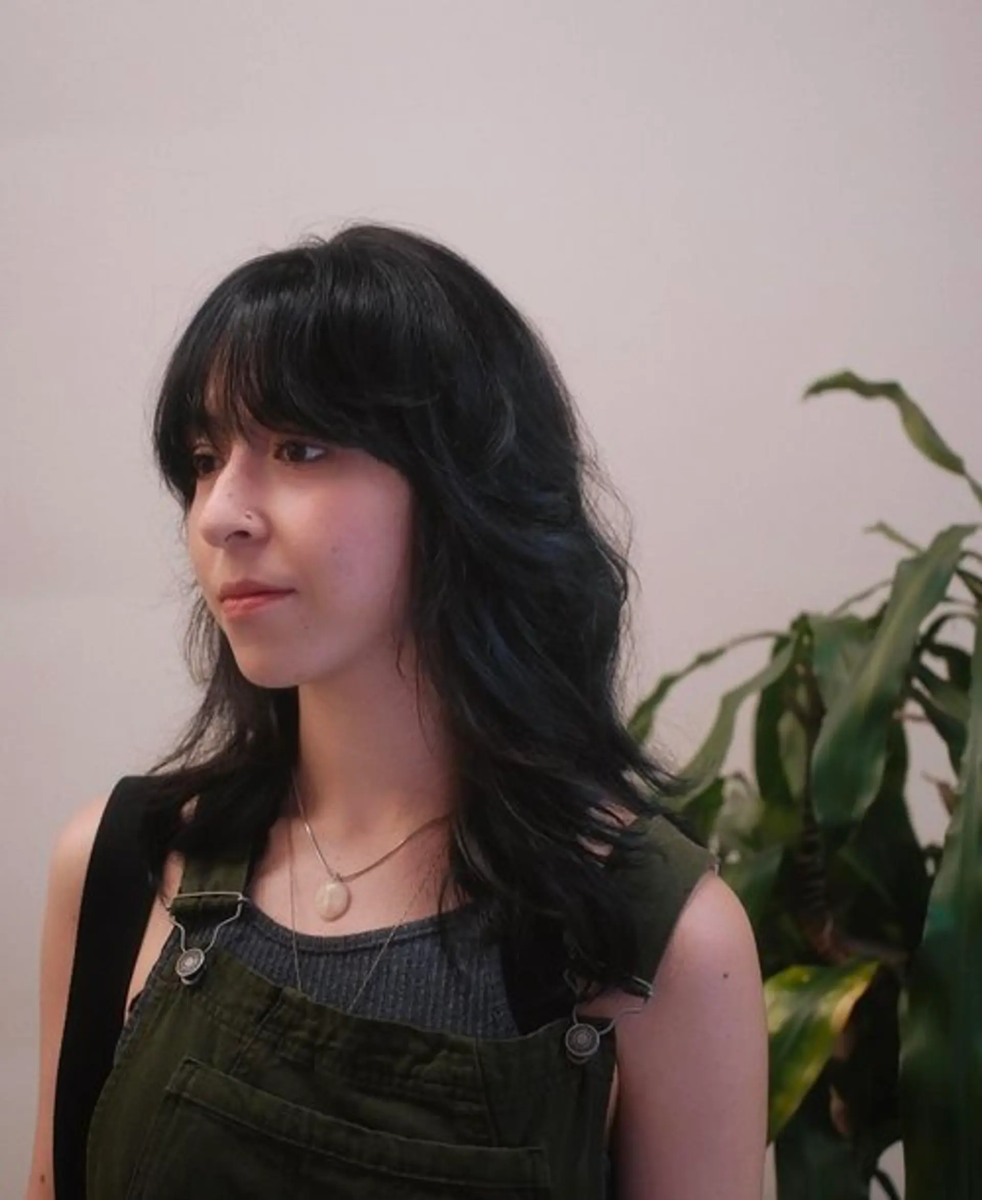 A medium-length wavy shag with choppy layers and curtain bangs. 1