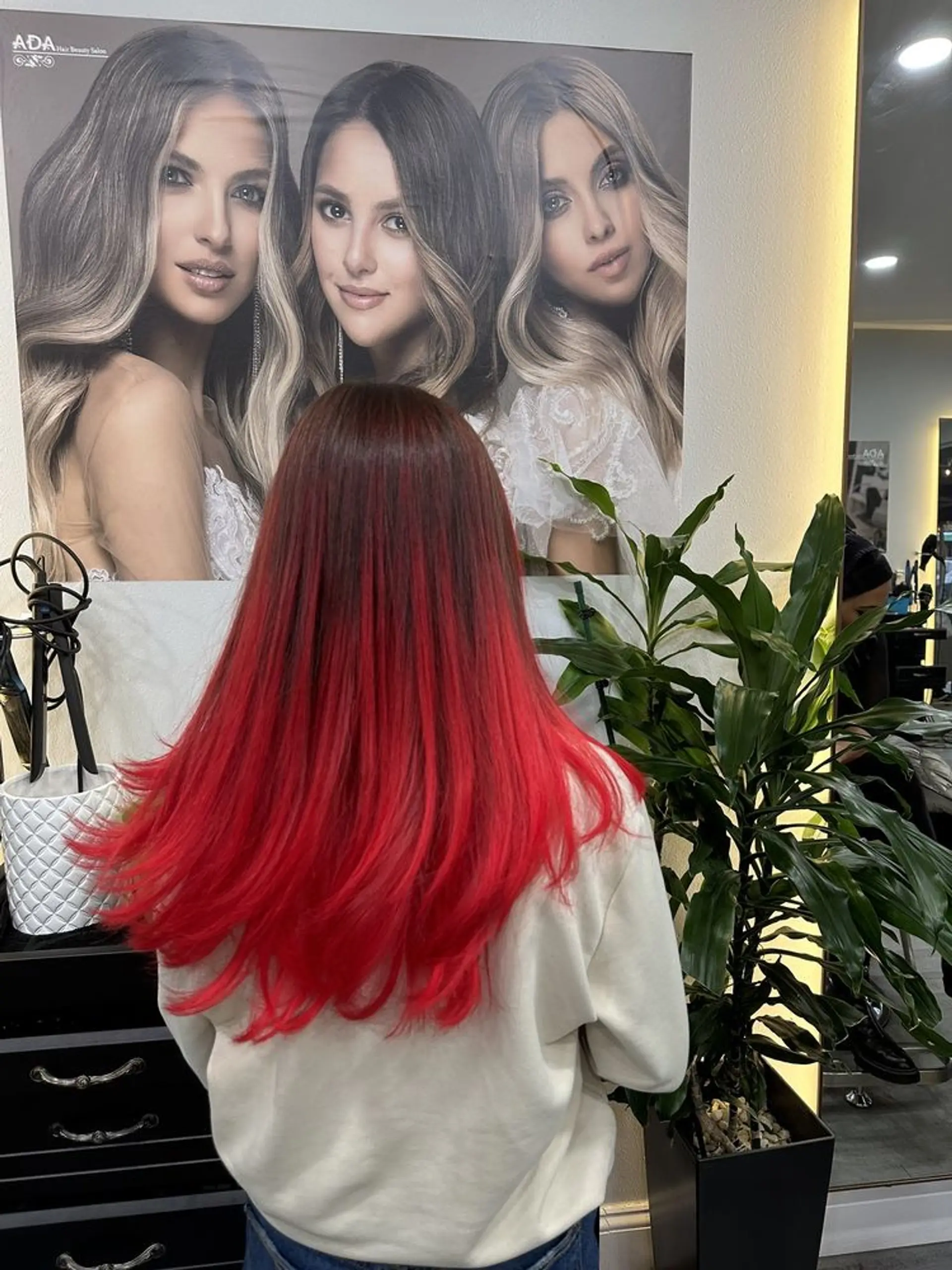 Long, layered hair featuring a dark brown to crimson red color melt. 1