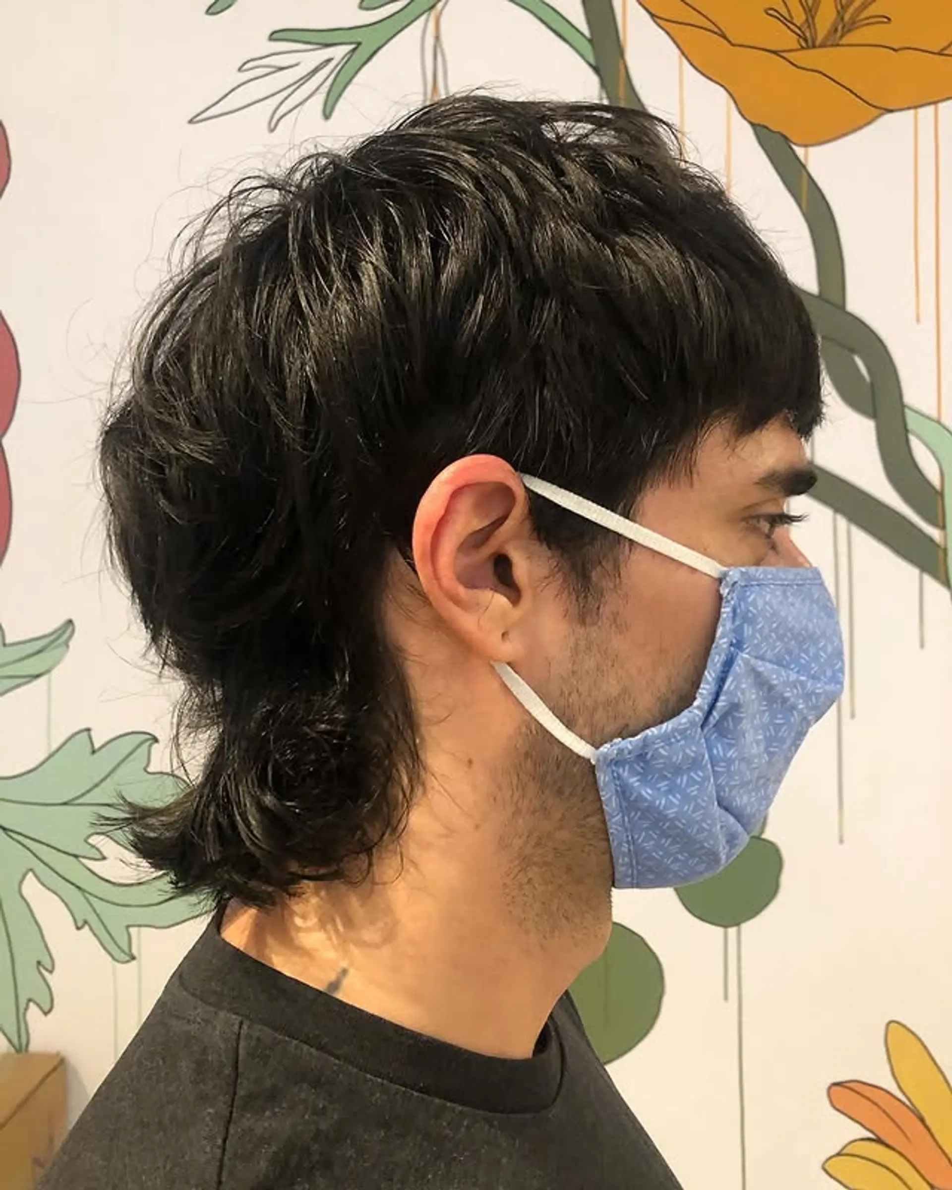 A contemporary mullet featuring short, textured layers on top and longer hair in the back. 1