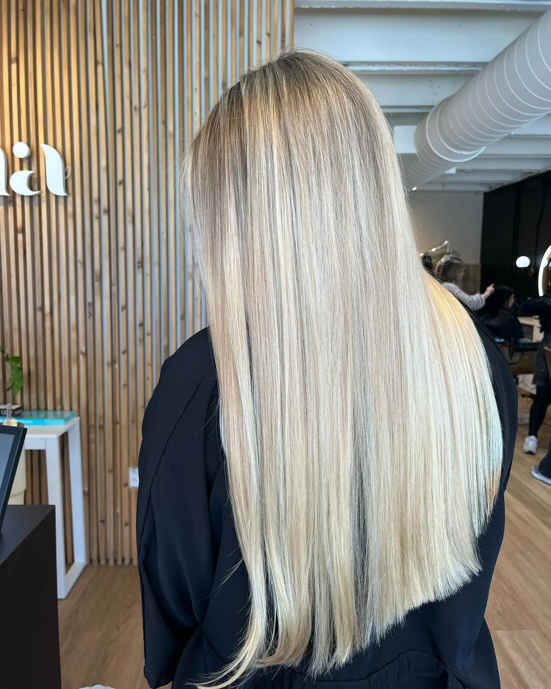 Extra-long sleek straight hair featuring seamless cool blonde highlights from root to ends. 1