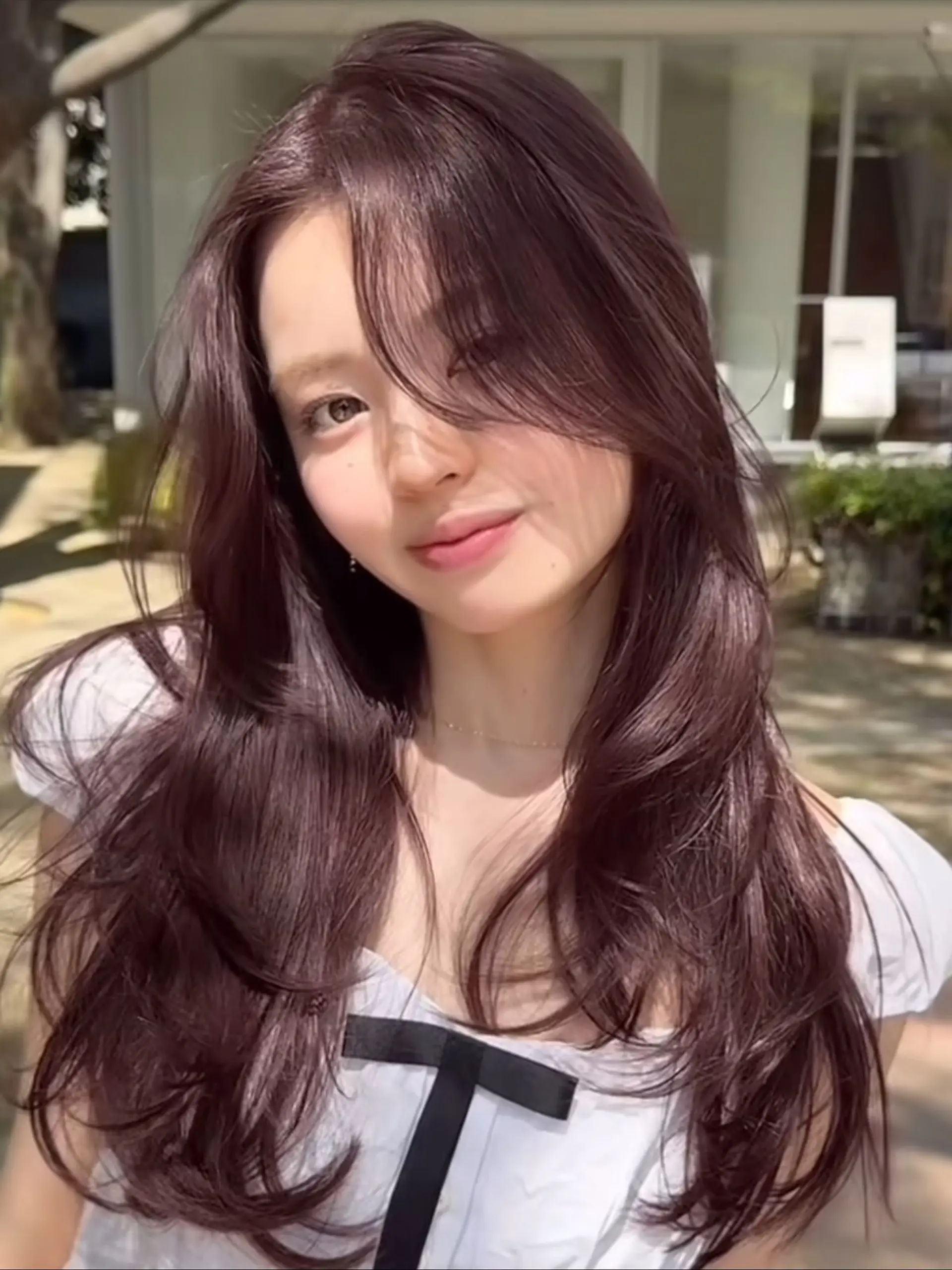 A long, layered hairstyle with face-framing bangs and soft waves. 1