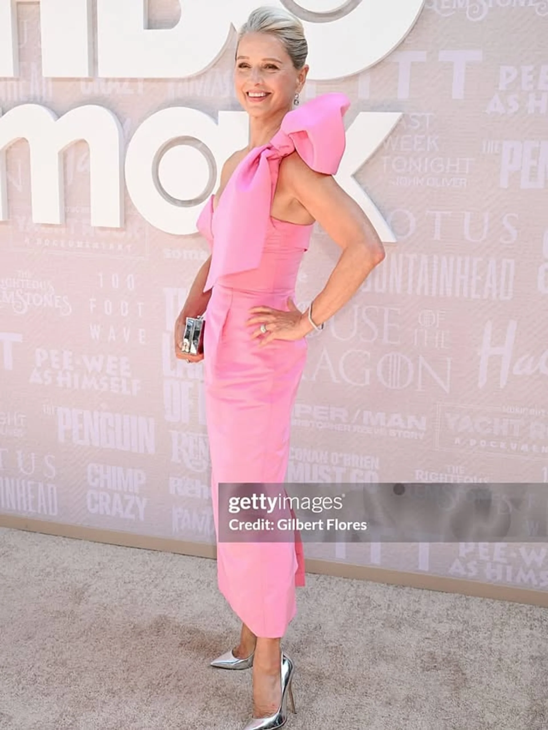 A woman with romantic, wavy hair styled in a half-up fashion, perfect for a red carpet event. - Preview 1