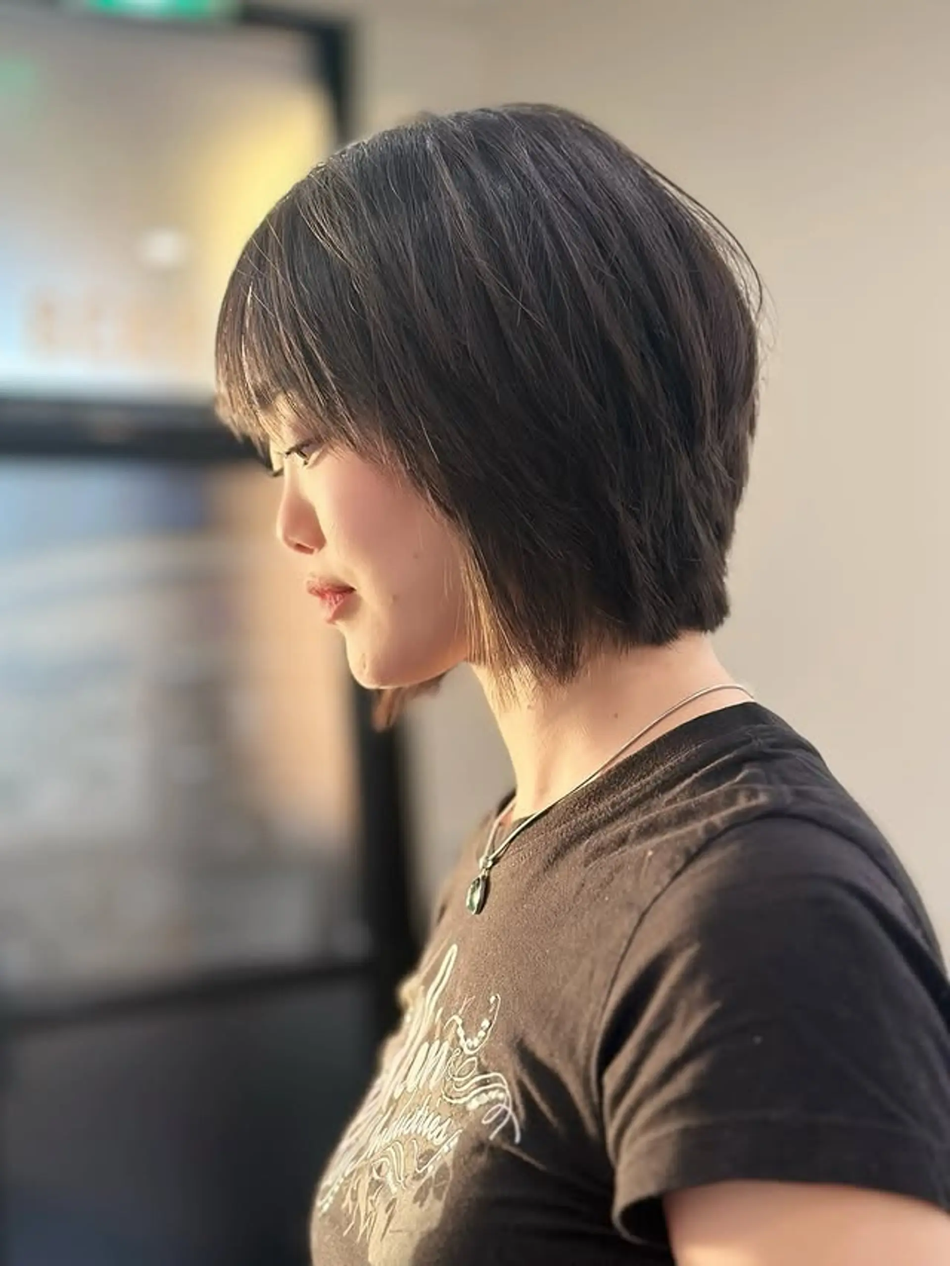 A stylish short bob with a blunt perimeter, textured ends, and a full fringe. 1