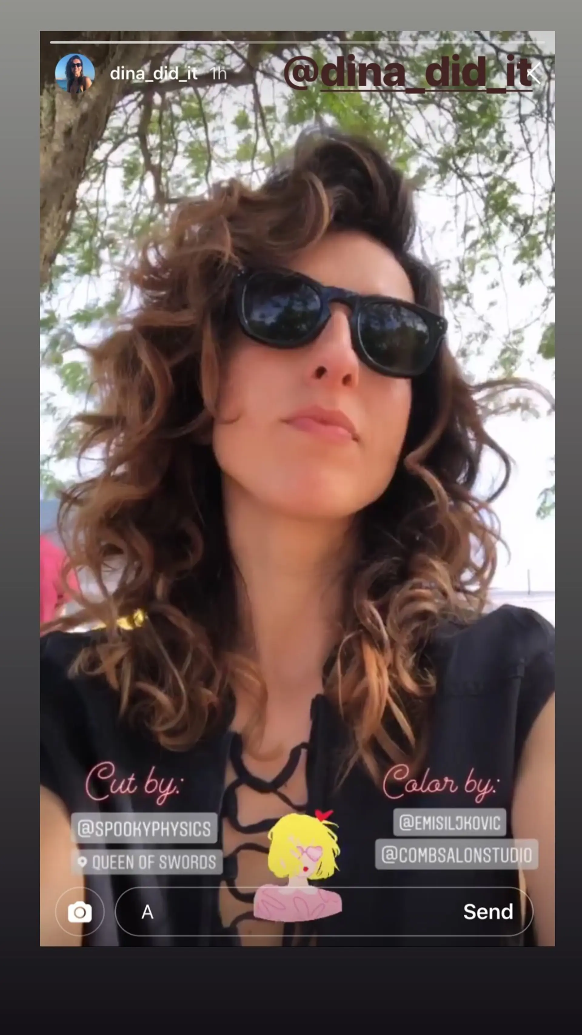 This medium-length curly hairstyle features defined ringlets with bronze highlights that add dimension and shine. 1