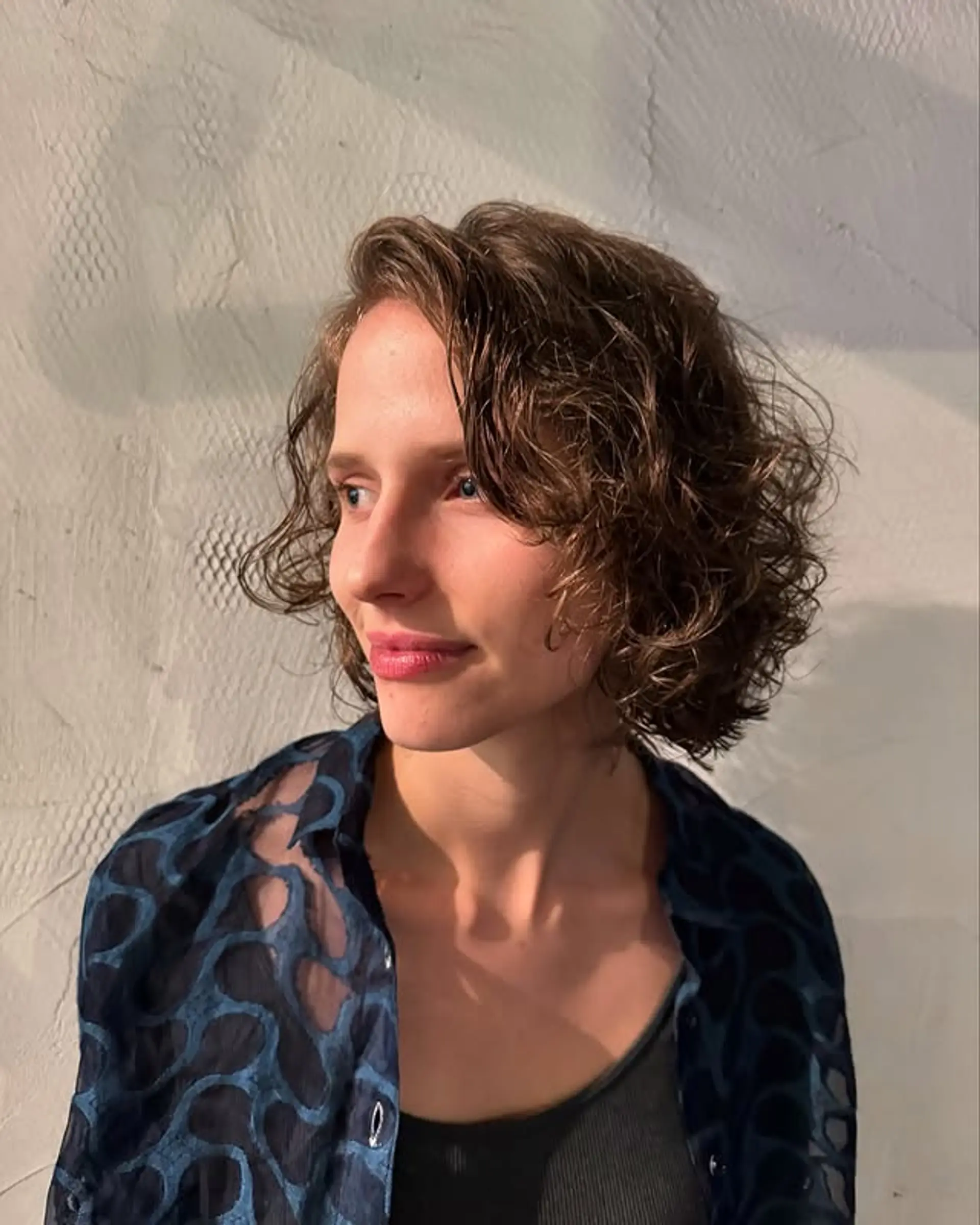 A textured curly bob that accentuates natural curls and adds volume. 1