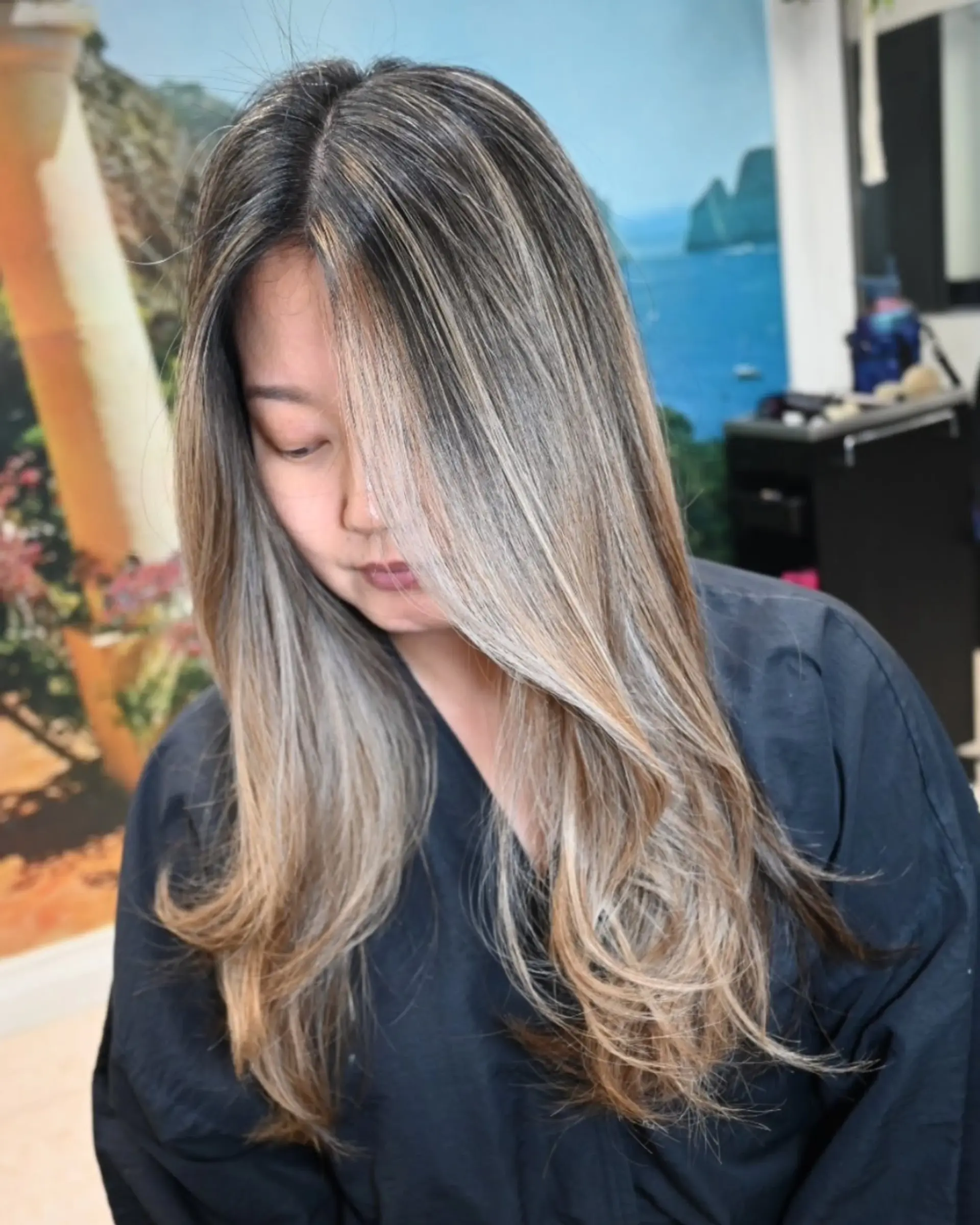 Long dark brown hair with fine ash blonde highlights, featuring bright face-framing money piece strands and soft flipped ends. 1