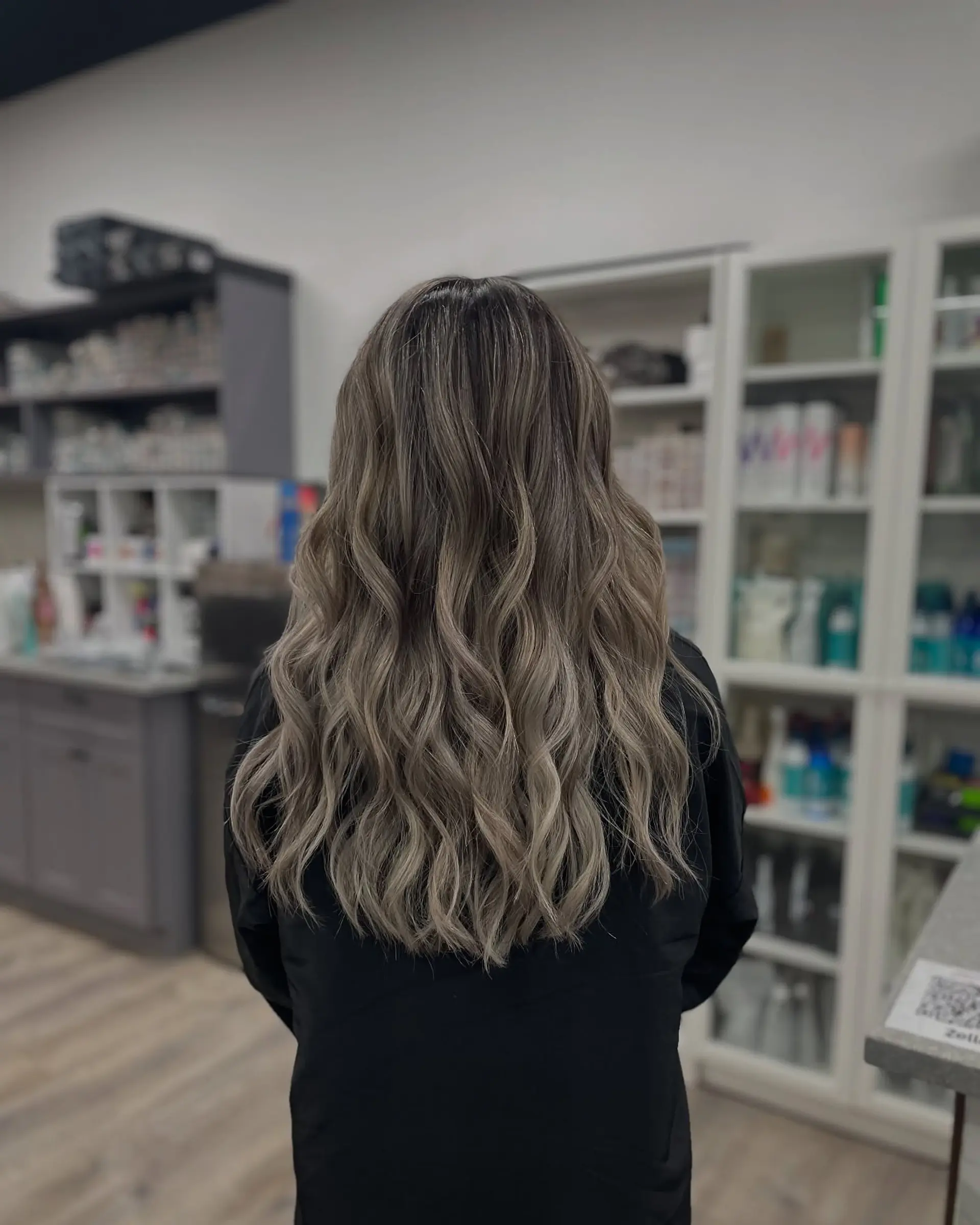 Long, wavy ash blonde balayage with soft, beachy waves. 1