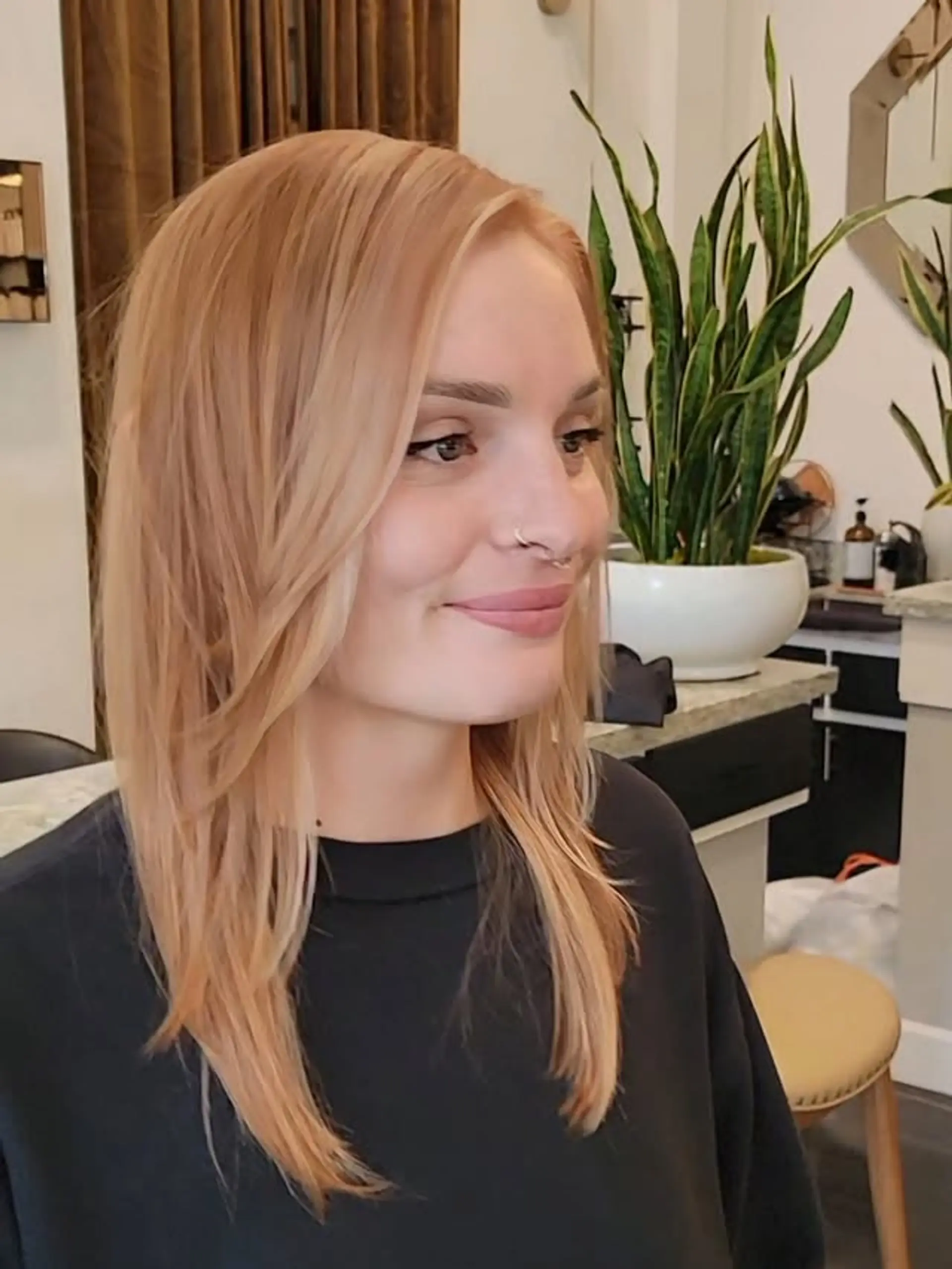 Medium-length hair styled with soft, cascading layers that beautifully frame the face and add movement and volume throughout the ends. The overall look is polished yet effortless. 1