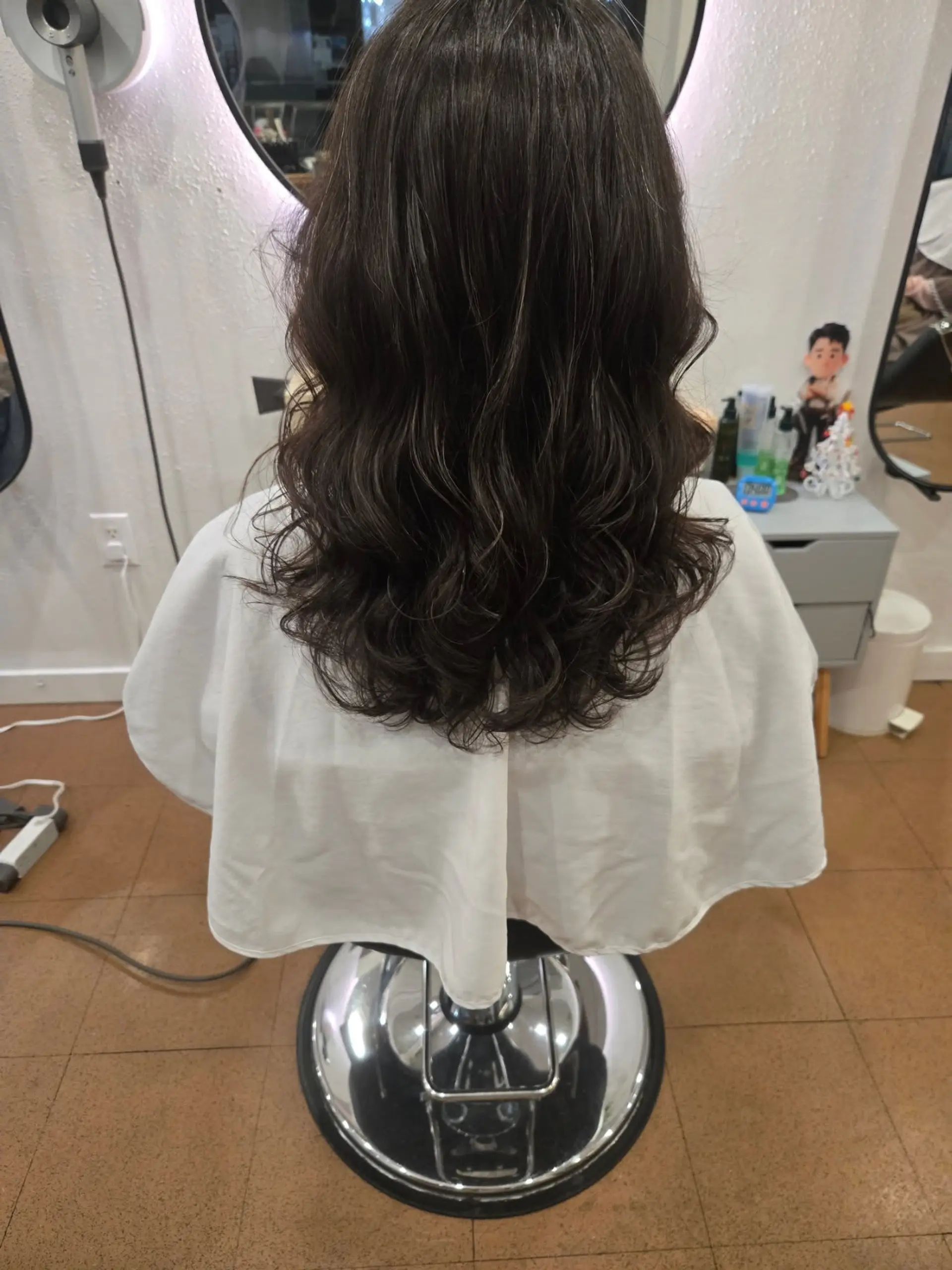 Medium-length dark hair styled into soft, natural digital perm waves with defined, cascading ends. 1