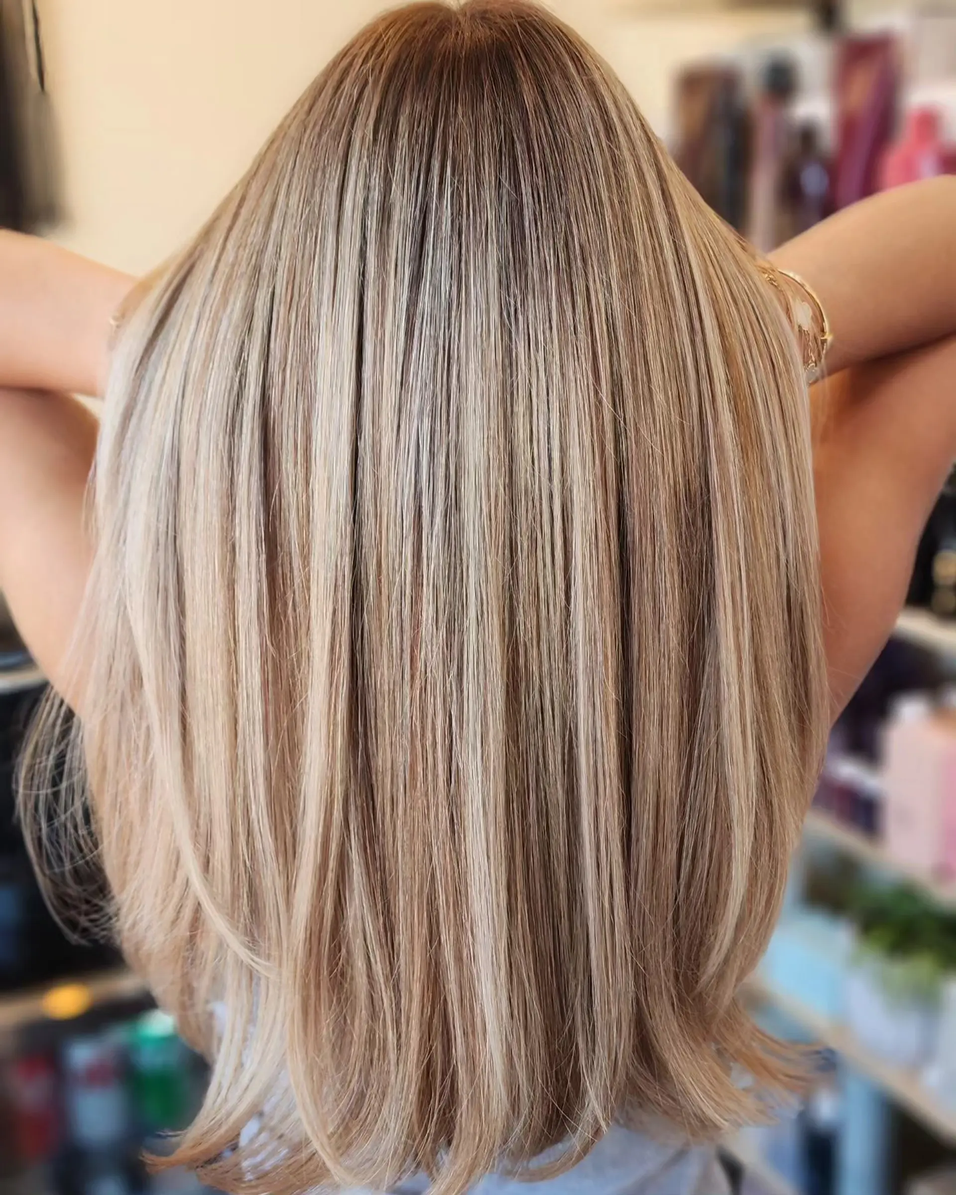 Smooth, long layered hair with finely blended dimensional beige blonde highlights and a soft natural root. 1