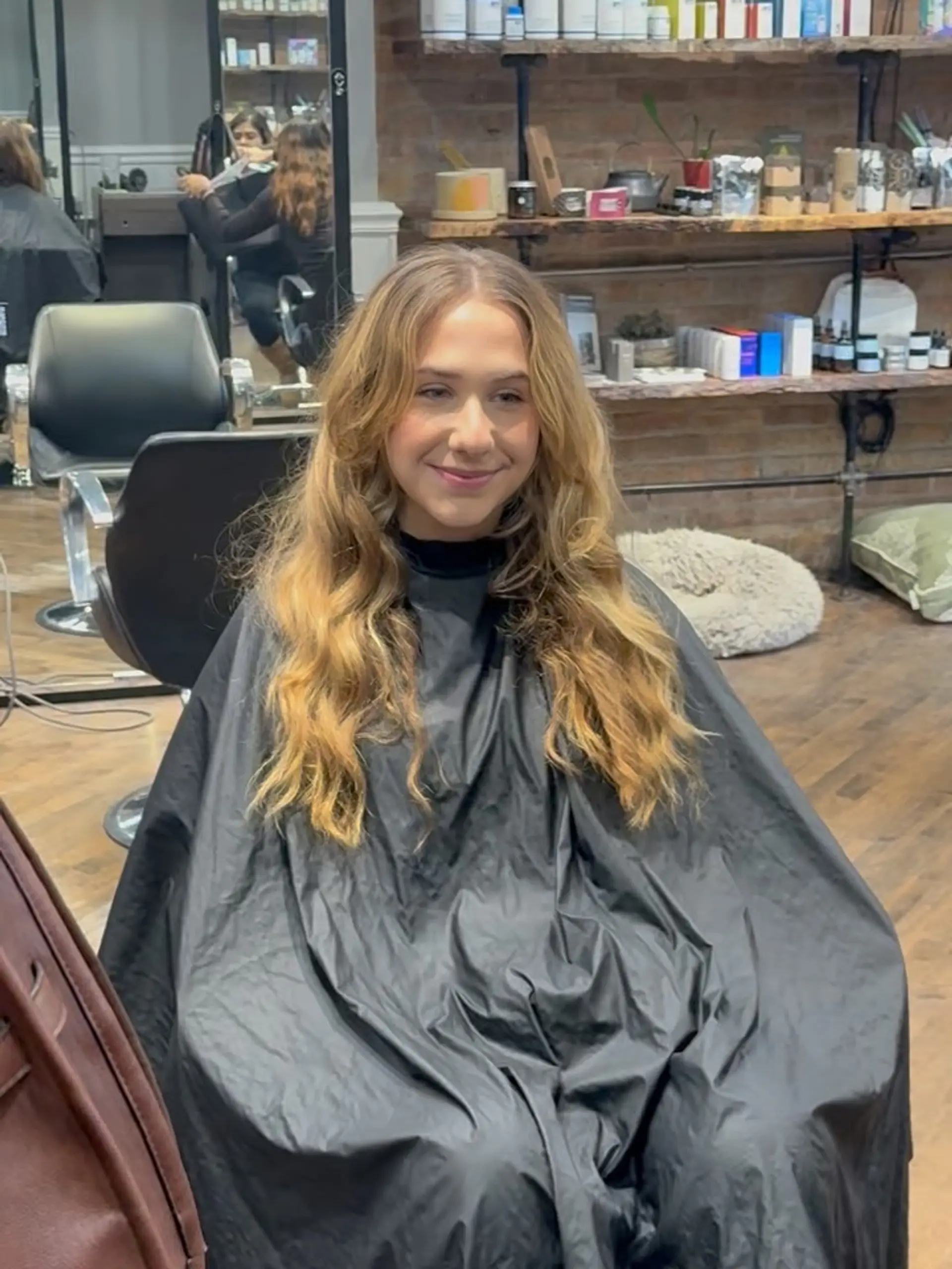 Long golden blonde hair cut with soft, face-framing layers and styled into relaxed waves. 1