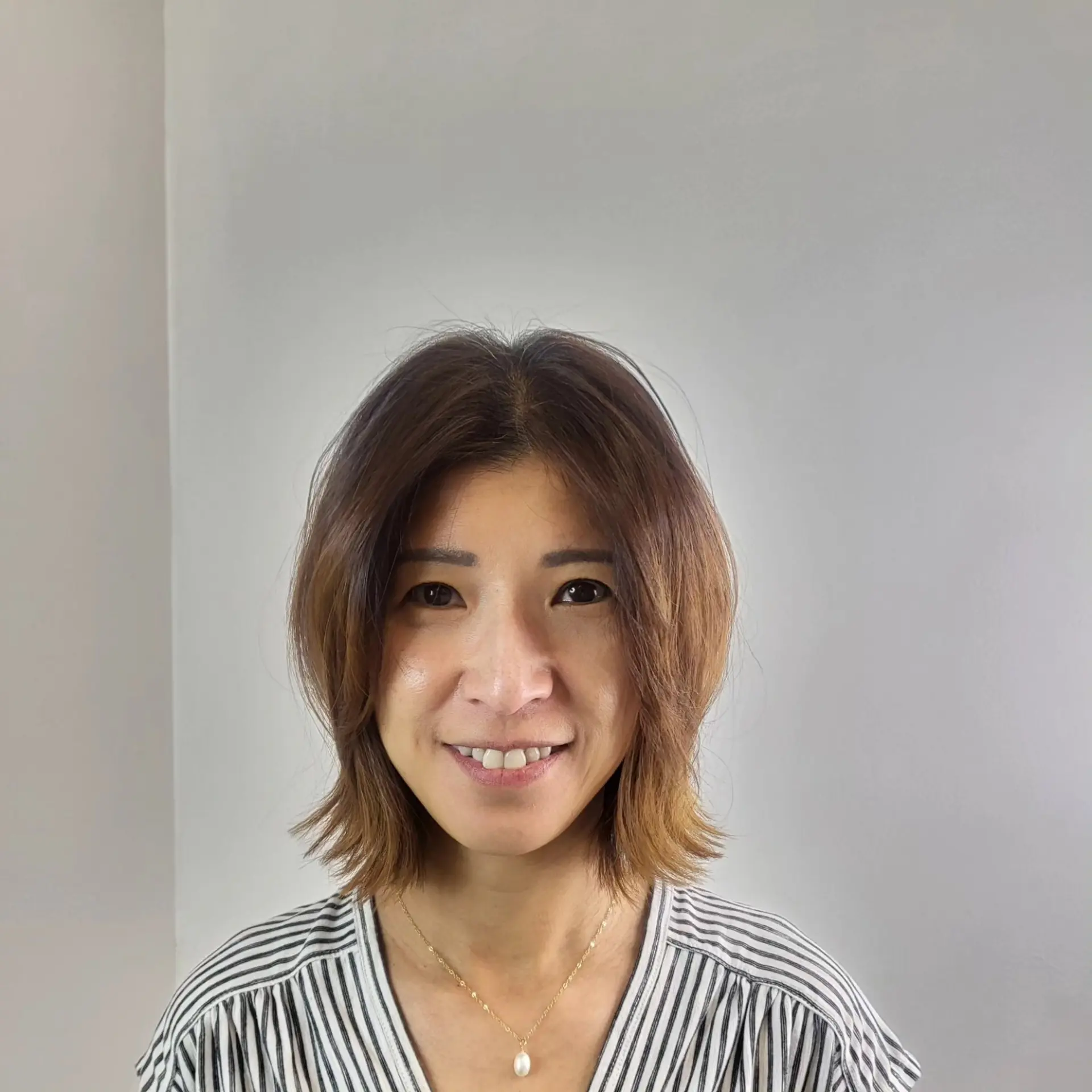 A textured, layered neck-length bob featuring soft face-framing pieces and flipped-out ends for an airy, dynamic look. 1