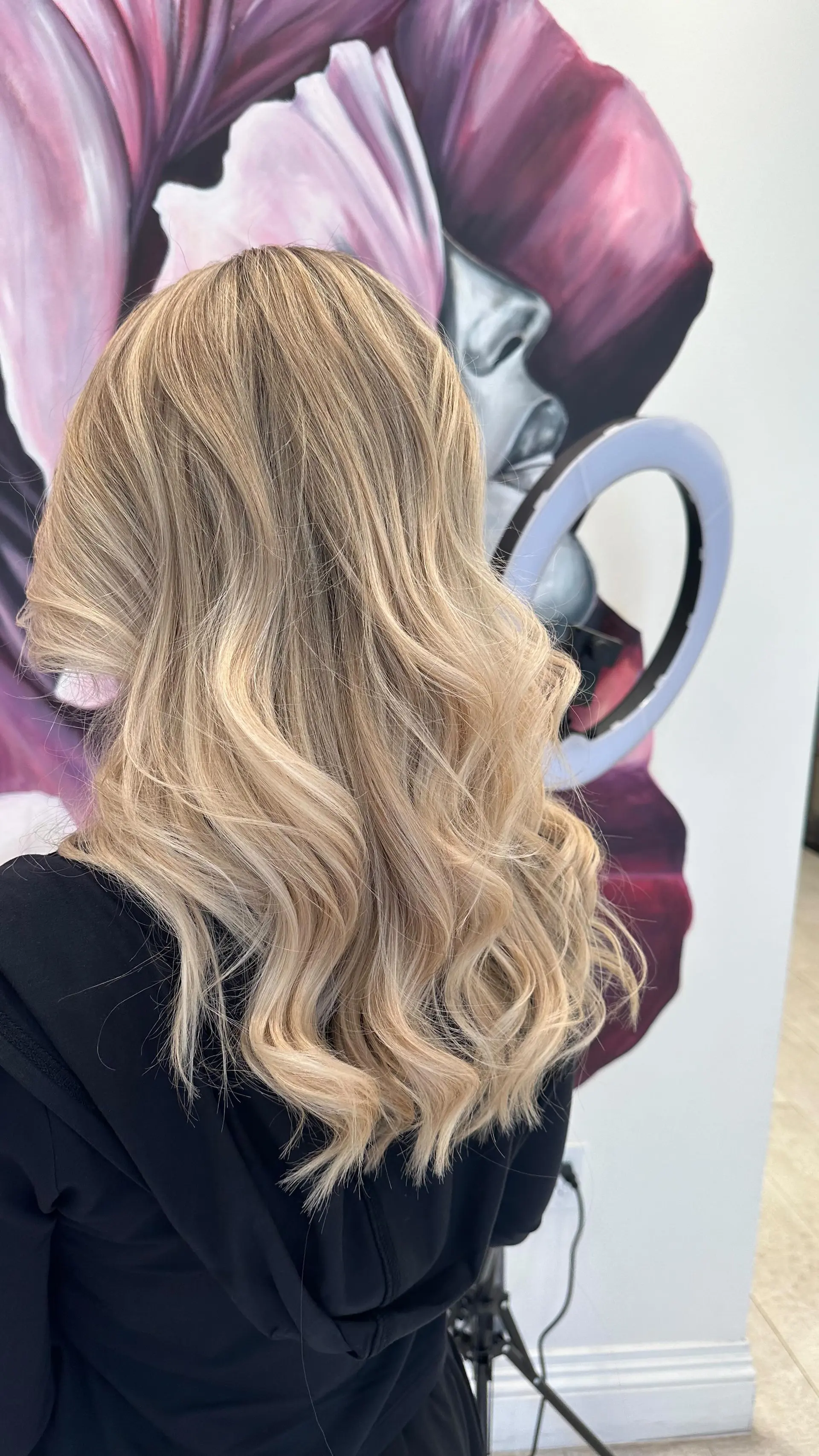 Long ash blonde hair with dimensional highlights styled into loose, polished waves. 1