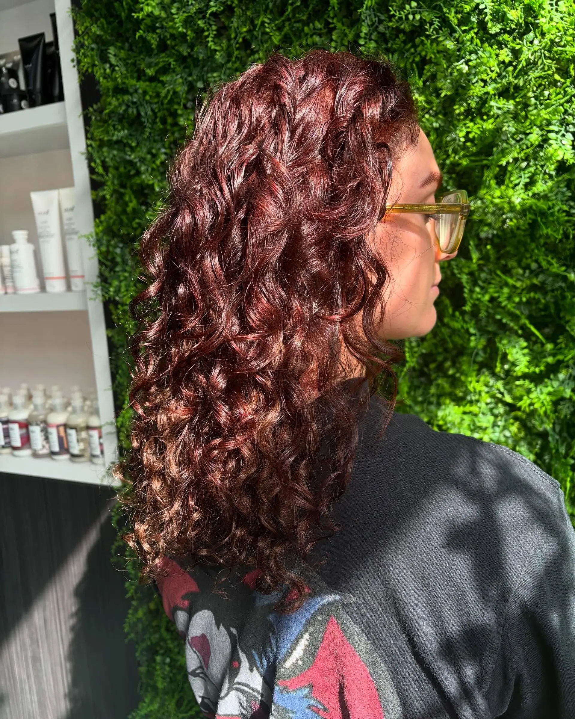 Medium length curly hair with auburn color and highlights. 1