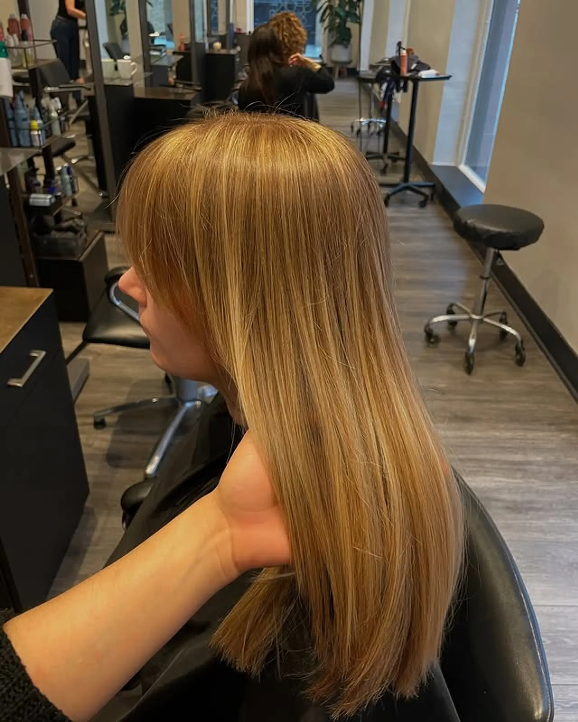 Long, straight hairstyle with full bangs and subtle face-framing layers. 1