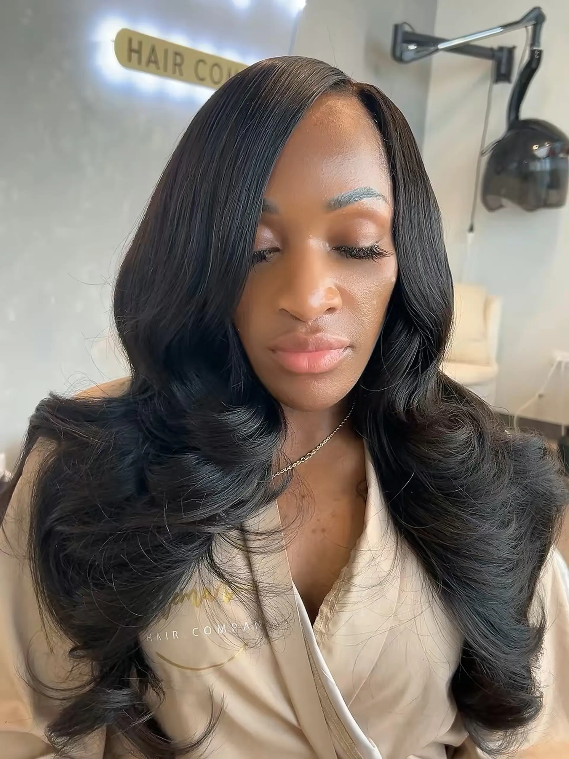 Glamorous long waves with a sleek side part, achieved with a sew-in weave. 1