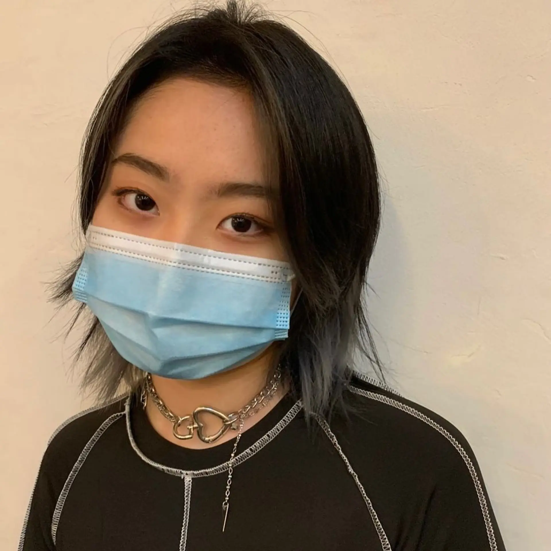 A medium-length edgy layered wolf cut with straight black hair accented by bold gray highlights. It features uneven layers and jagged ends for a voluminous and textured appearance. (Hair by Nori) 1