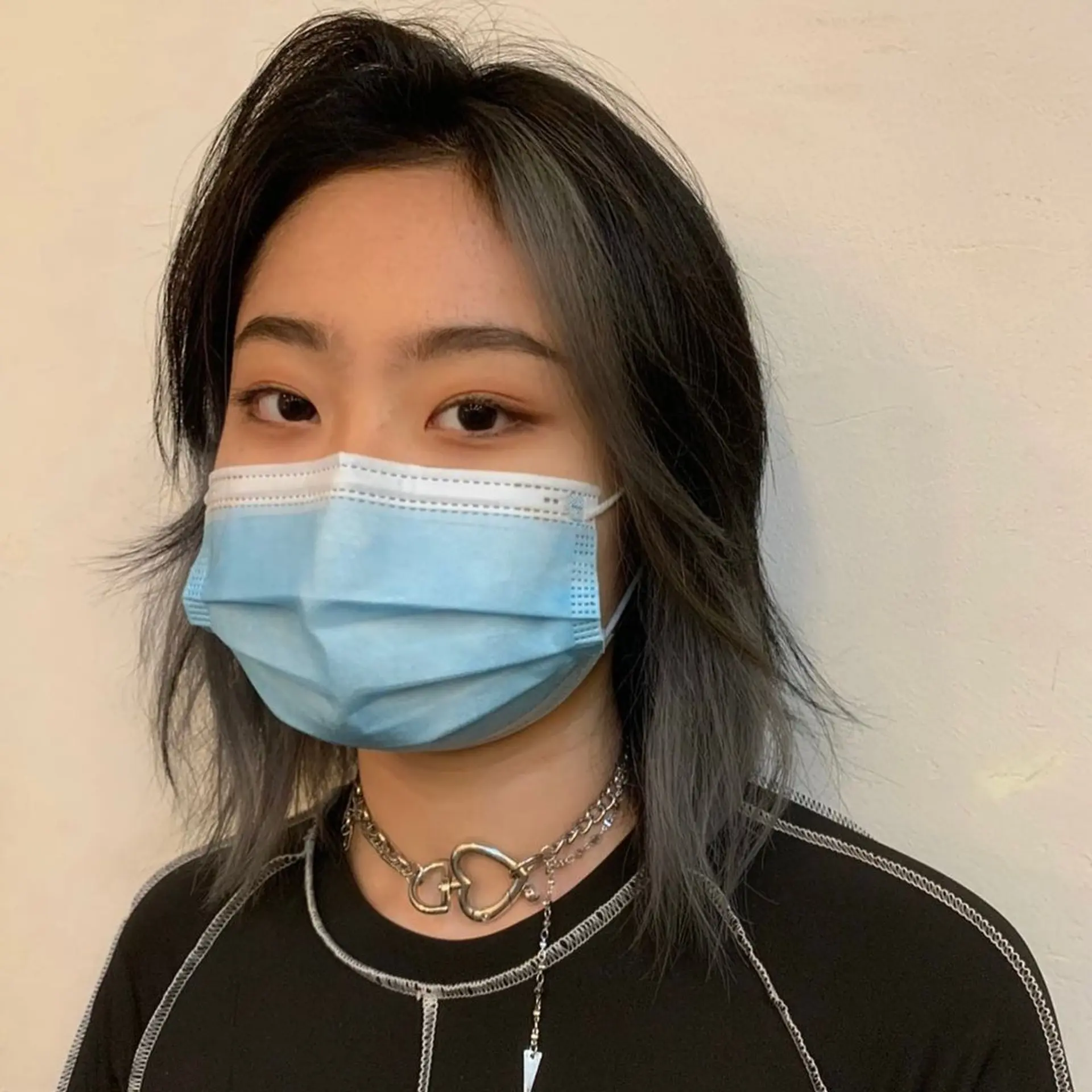 A medium-length edgy layered wolf cut with straight black hair accented by bold gray highlights. It features uneven layers and jagged ends for a voluminous and textured appearance. (Hair by Nori) 2
