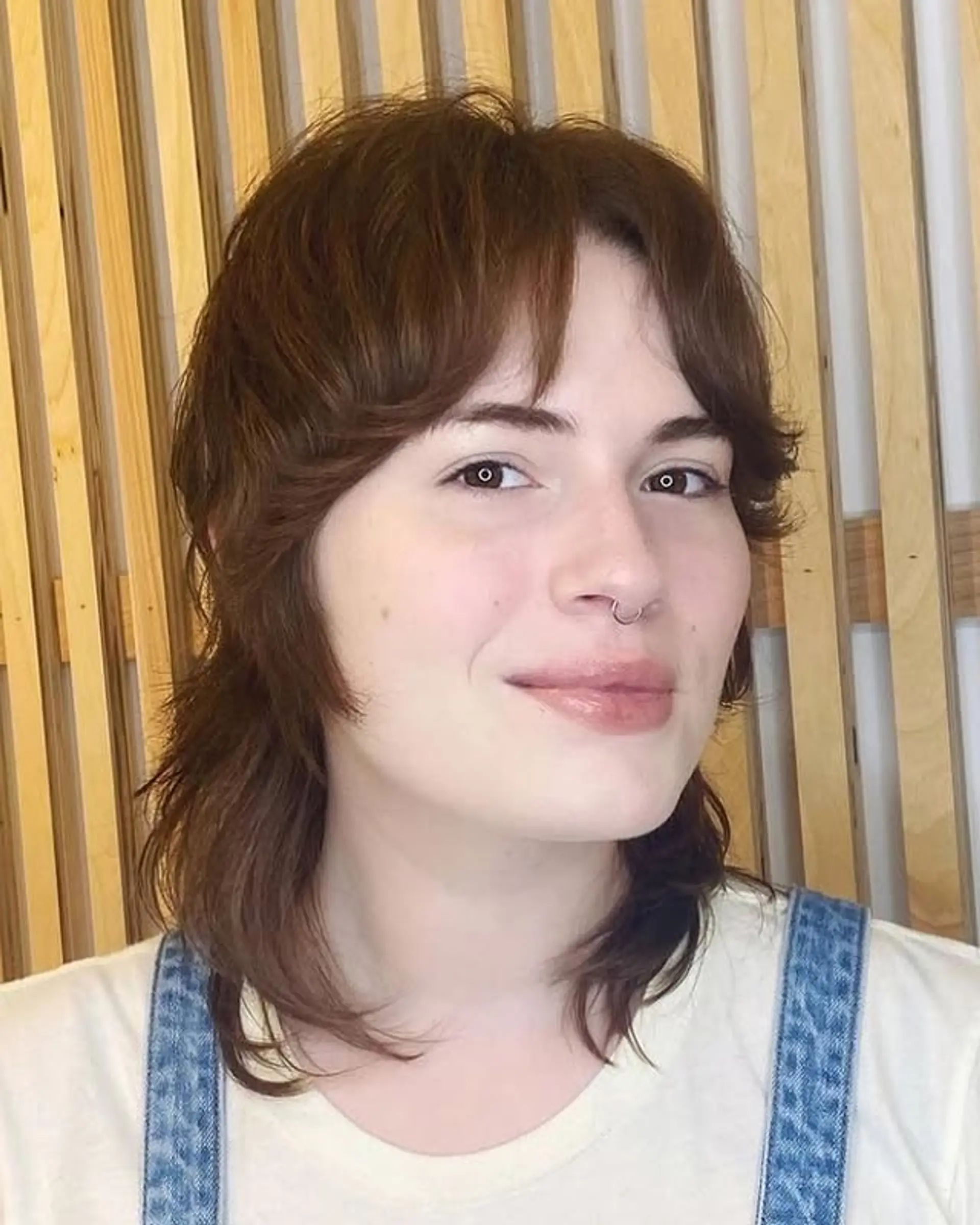 A choppy, layered shag mullet with curtain bangs. 1