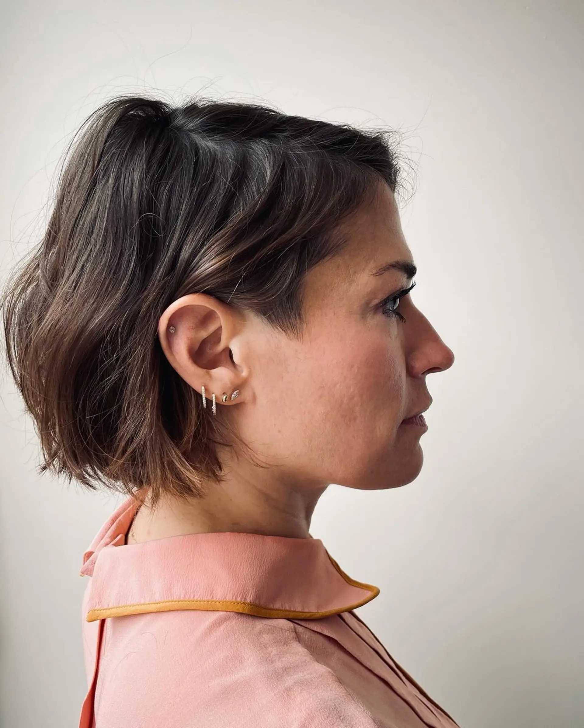 A short, wavy bob with a tousled, textured finish and subtle highlights for added depth. 2