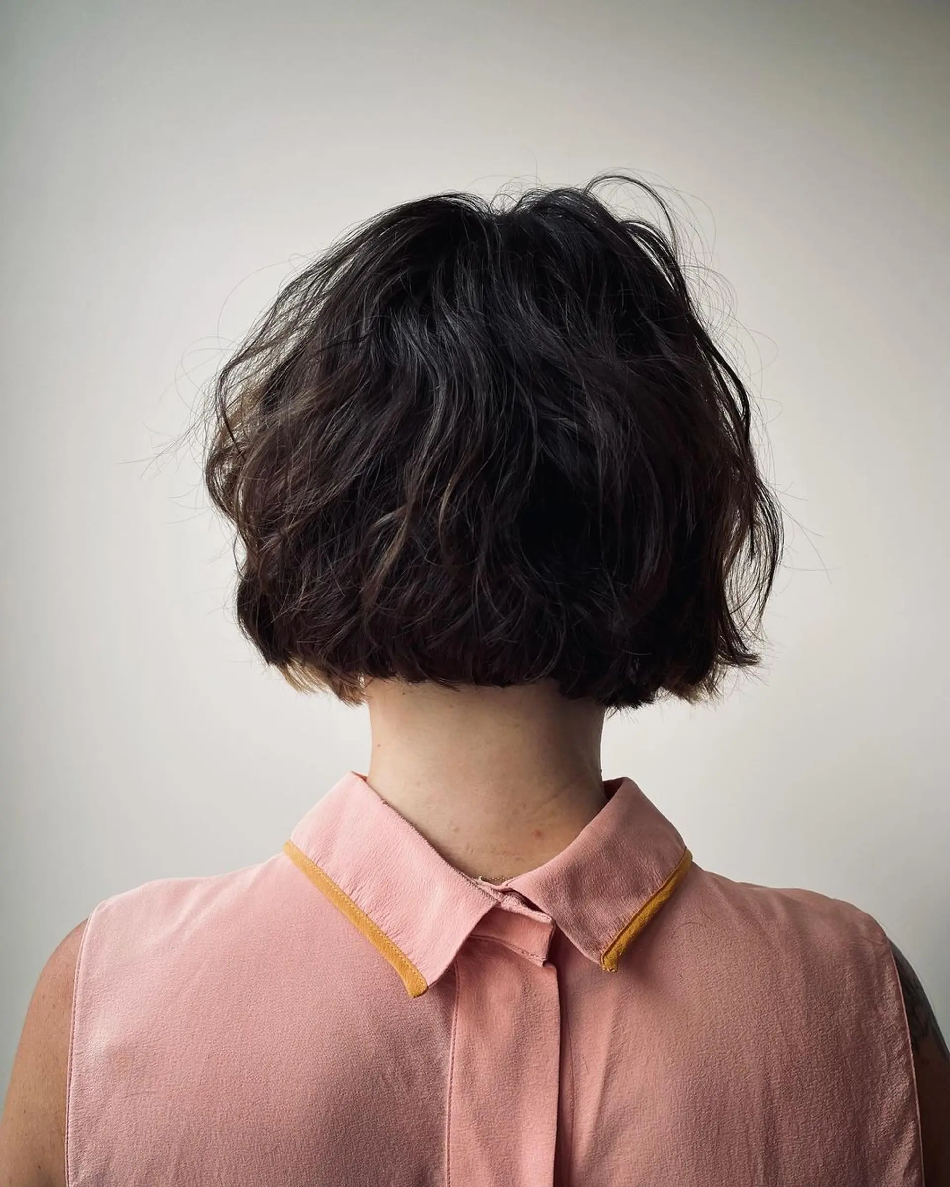 A short, wavy bob with a tousled, textured finish and subtle highlights for added depth. 3