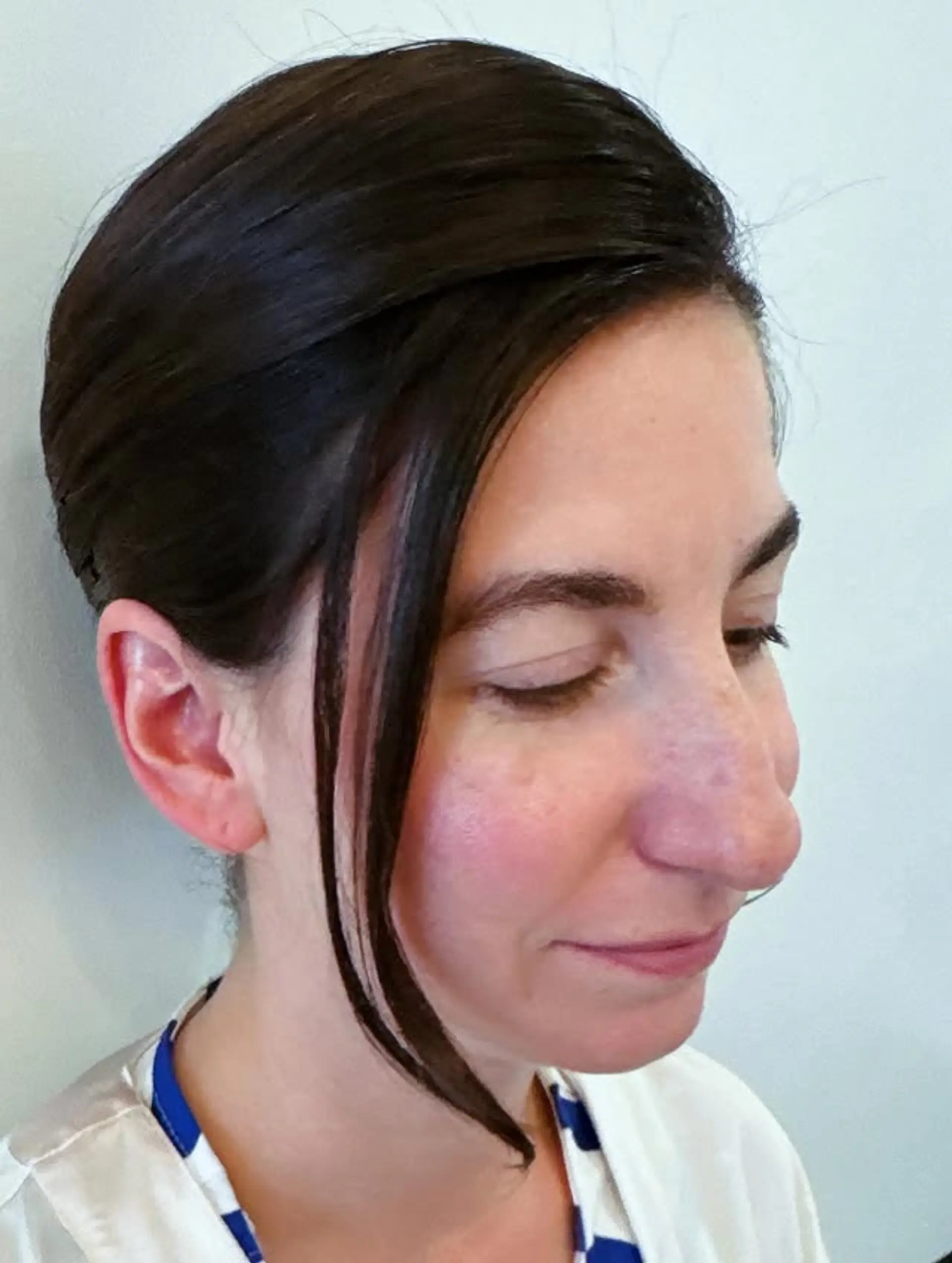 A sleek and sophisticated updo with a modern side bang detail, perfect for formal events. 1