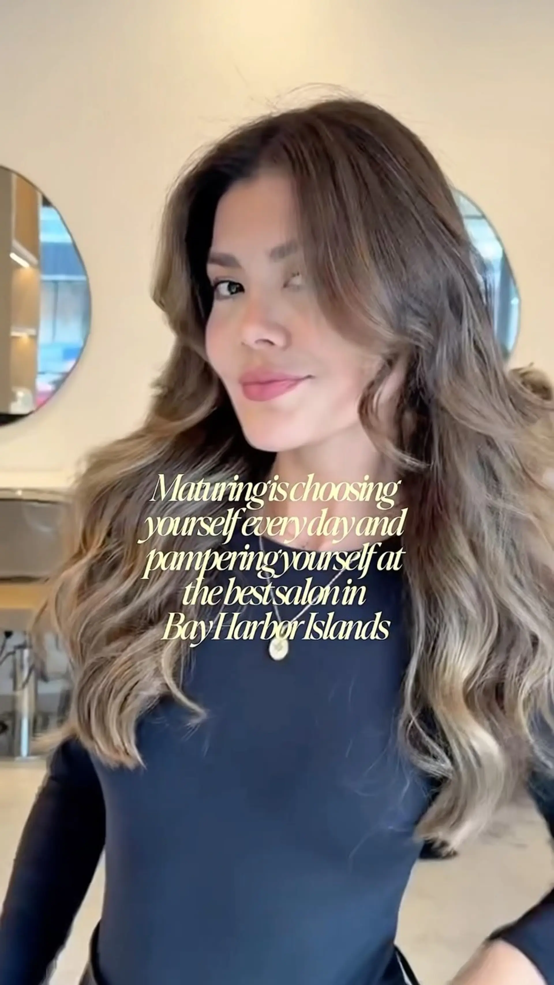 Long dimensional brunette hair styled in loose, voluminous waves with soft face-framing layers. 1