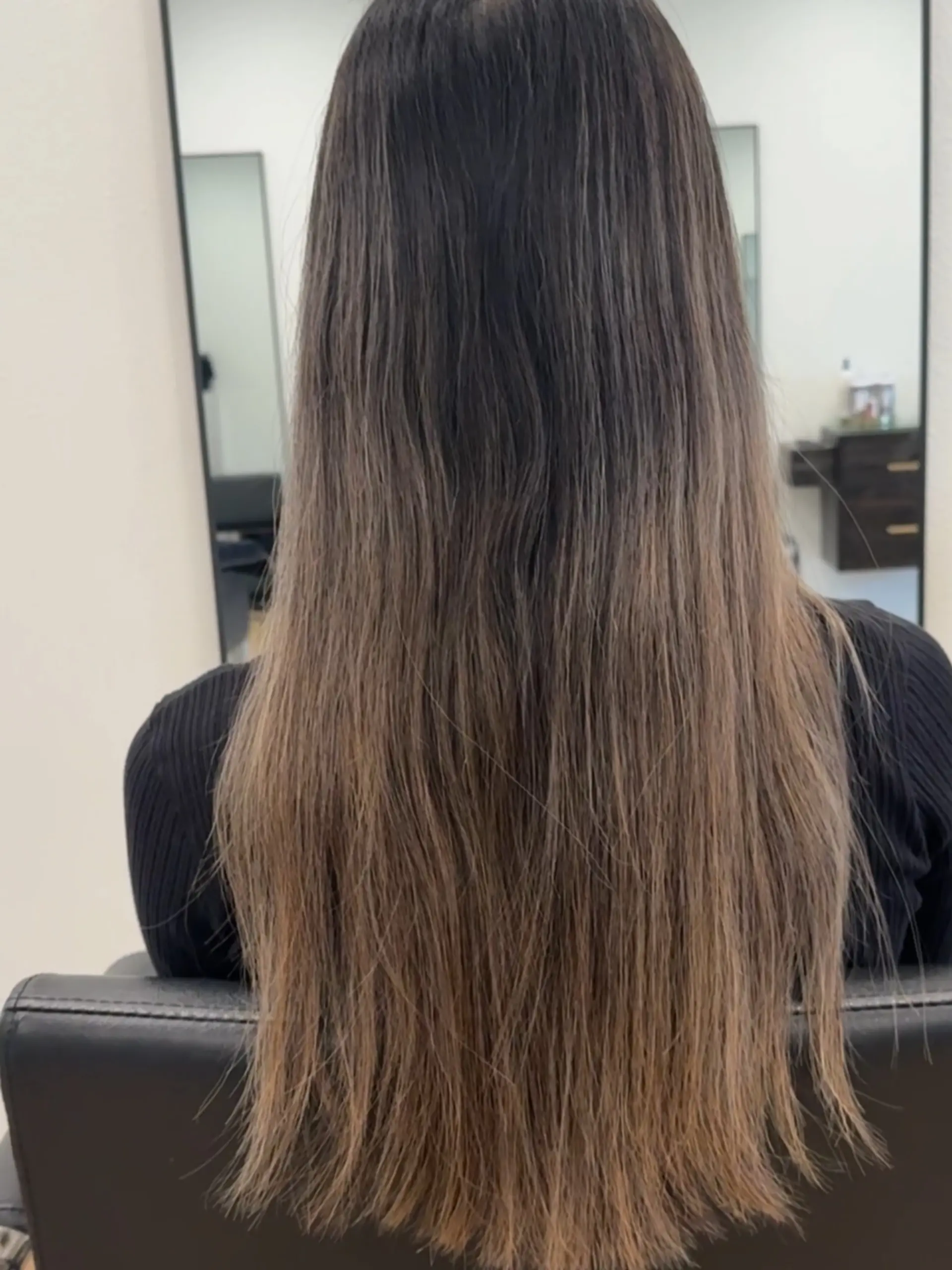Long, straight brunette hair featuring a subtle dimensional color melt from dark roots to lighter brown ends. 1