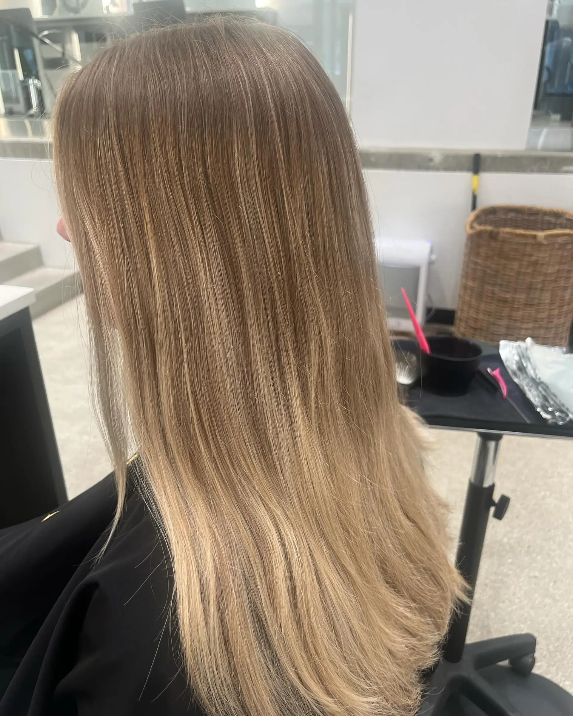 Medium length wavy hairstyle with blonde balayage and a shadow root. 2