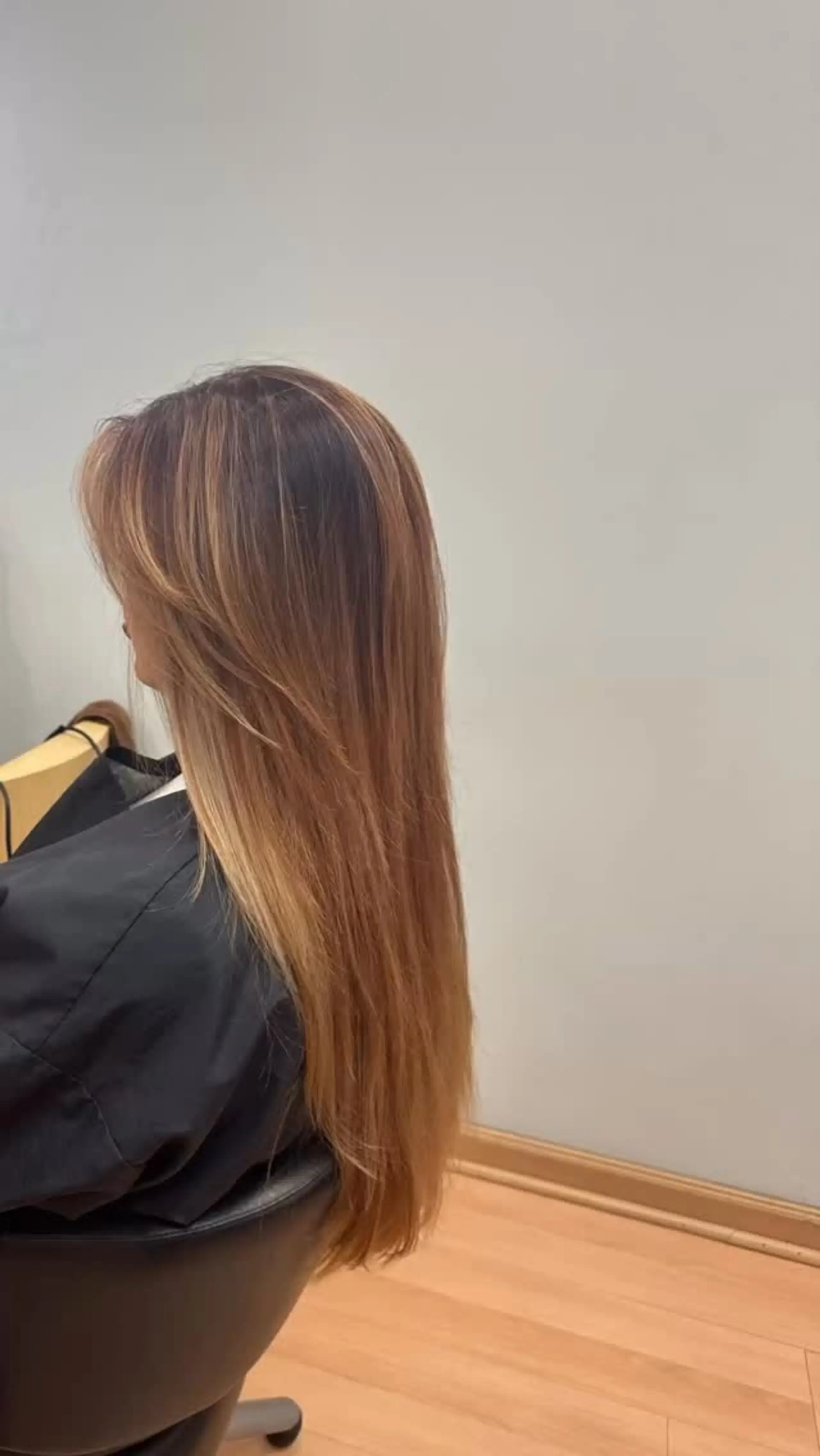 Straight, long hair featuring a warm caramel balayage with soft face-framing layers. 1