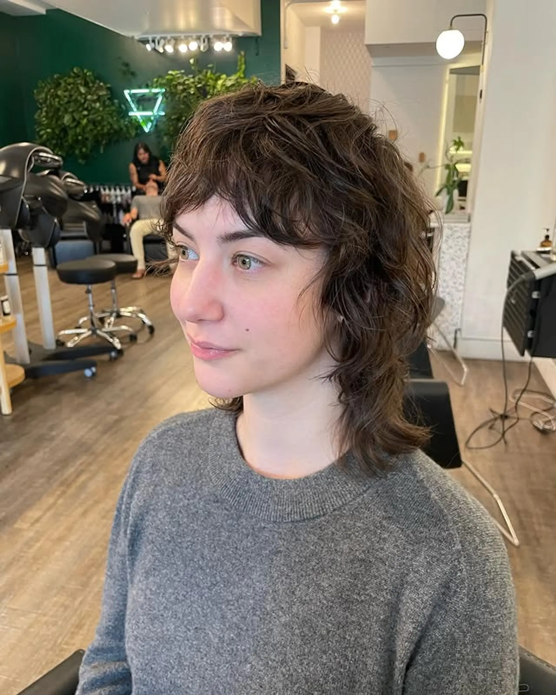 A textured shag mullet with choppy layers and wispy bangs. 1
