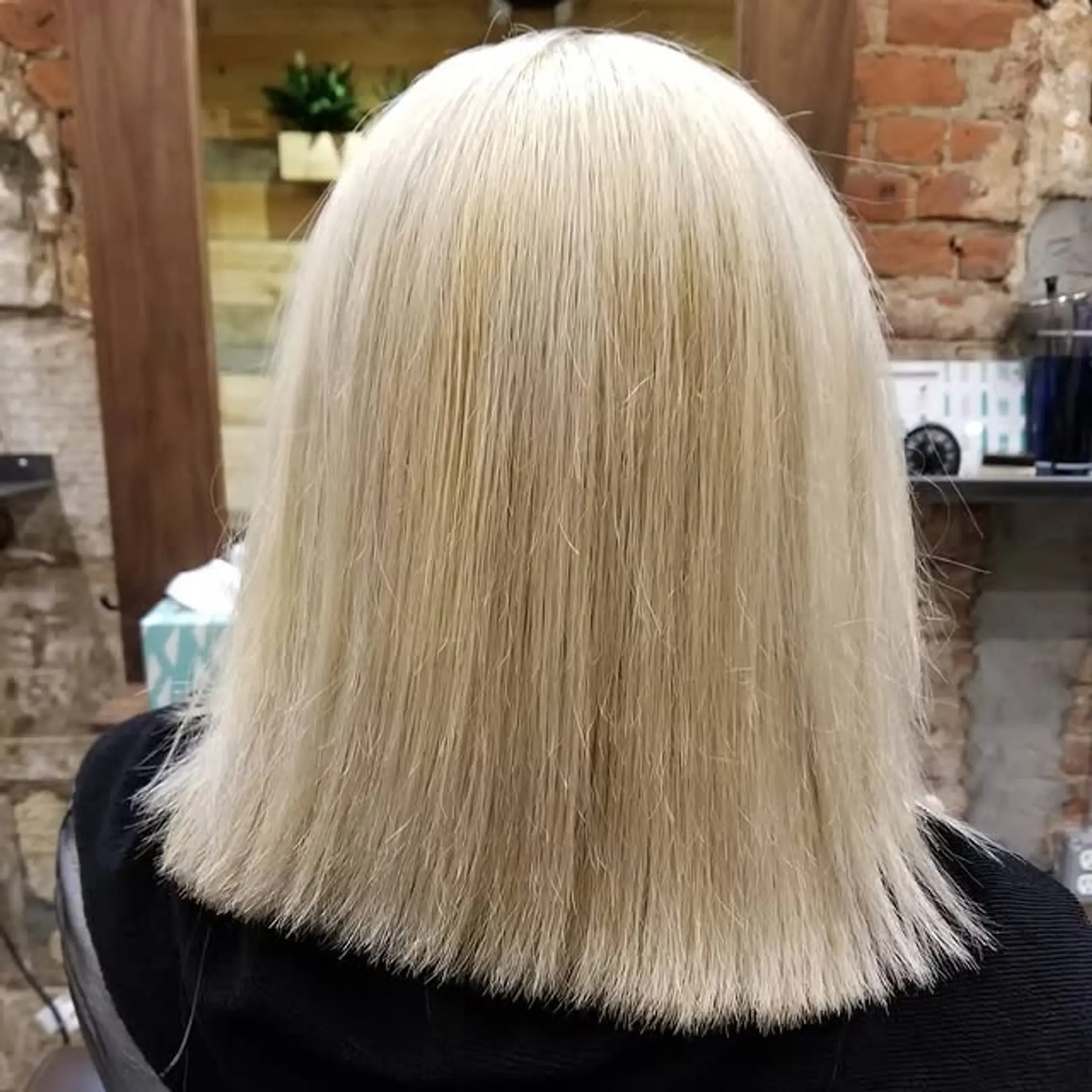 A sleek, straight blunt bob hairstyle with a clean, modern edge. 1