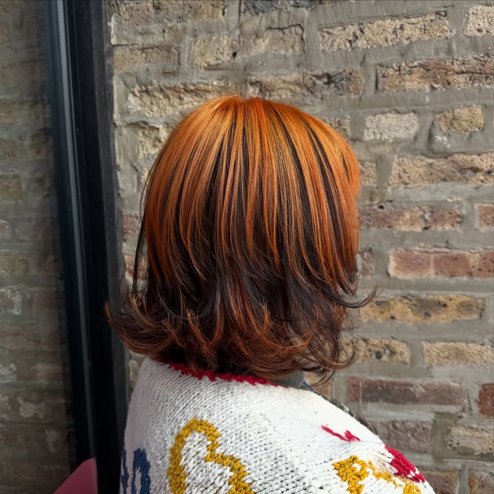 A trendy layered bob with copper balayage highlights. 1