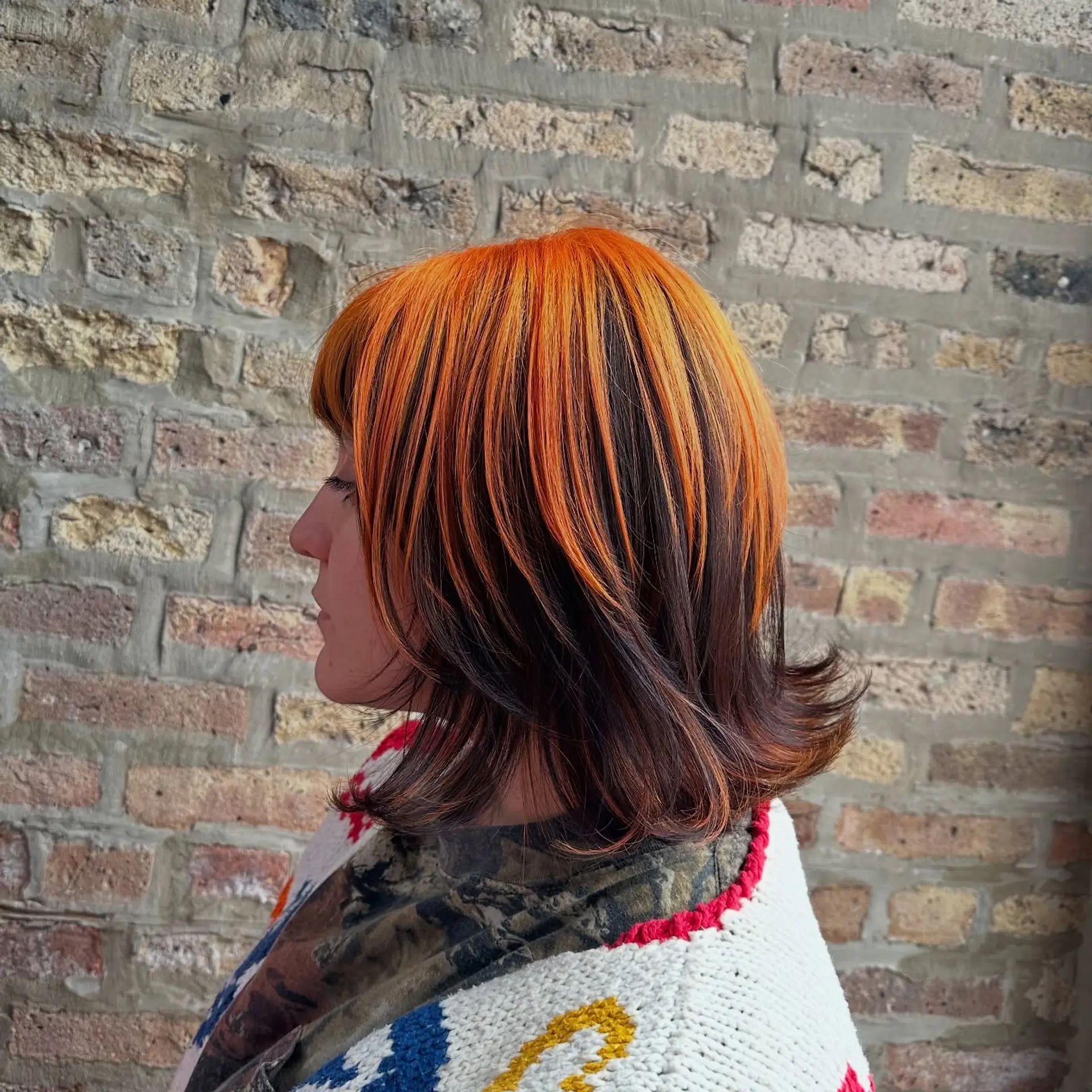 A trendy layered bob with copper balayage highlights. 3