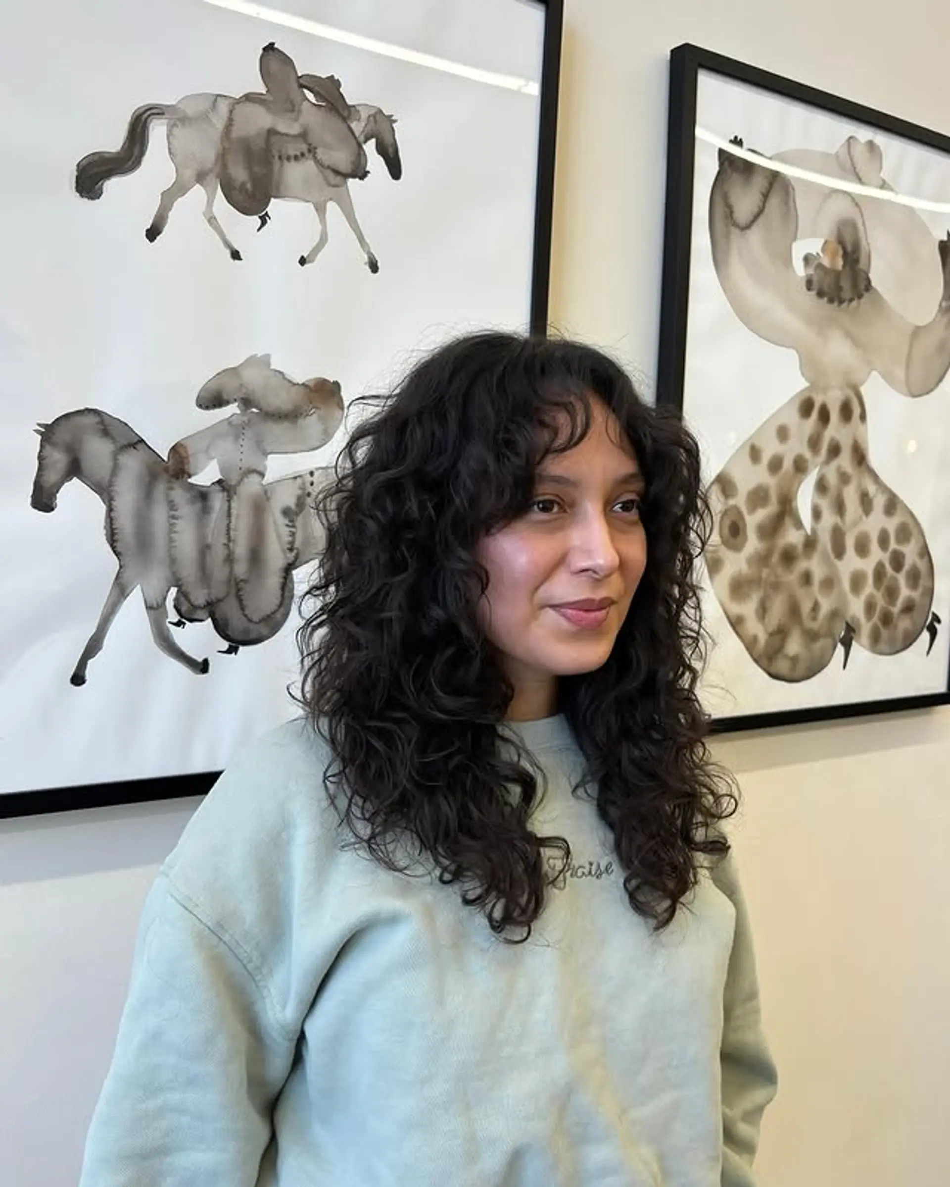 A mid-length shag haircut with natural looking curls and curly bangs. 1