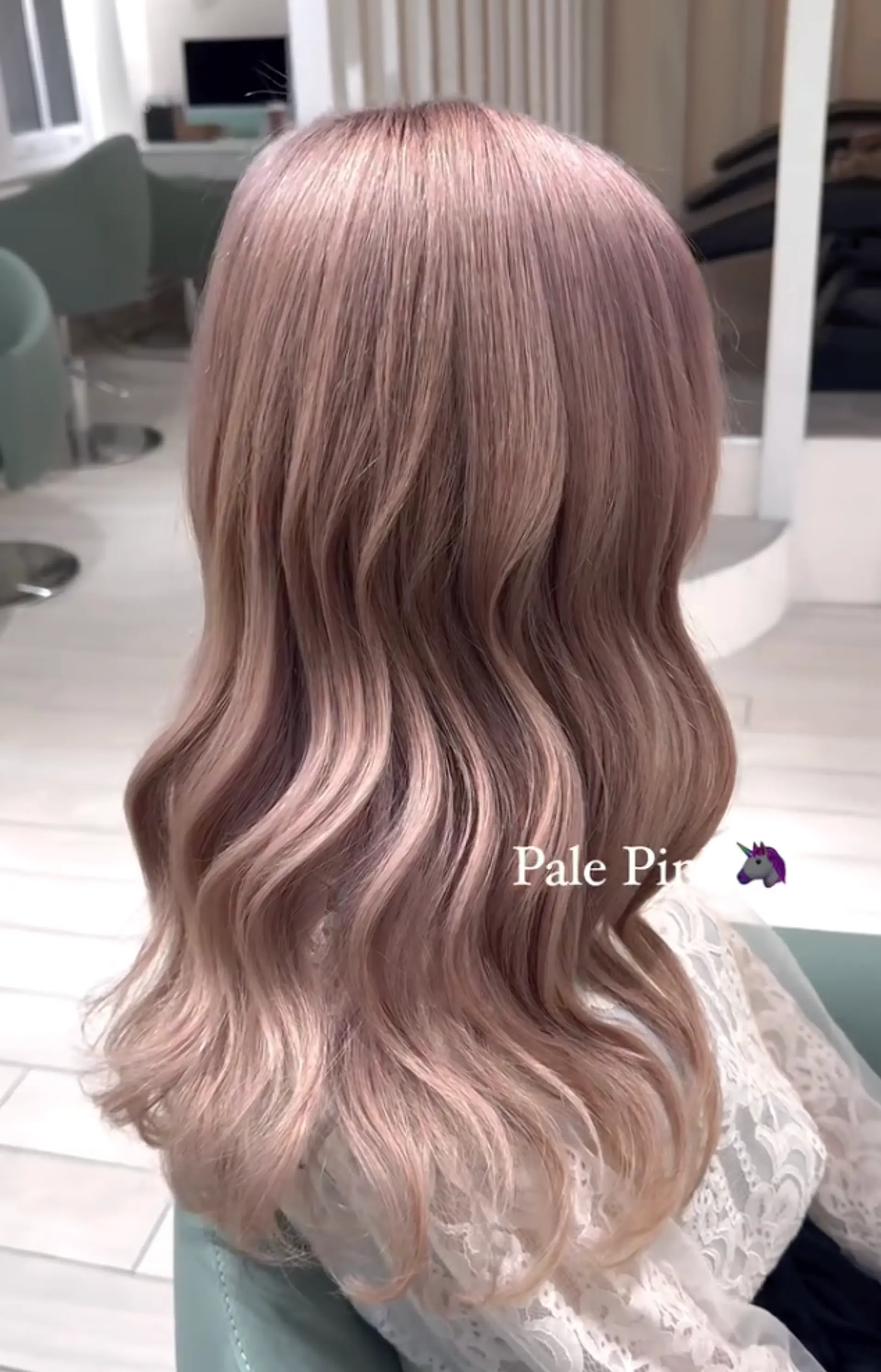 Soft, wavy locks cascading mid-length with pastel pale pink transitioning into blonde, reflecting a healthy shine. 1